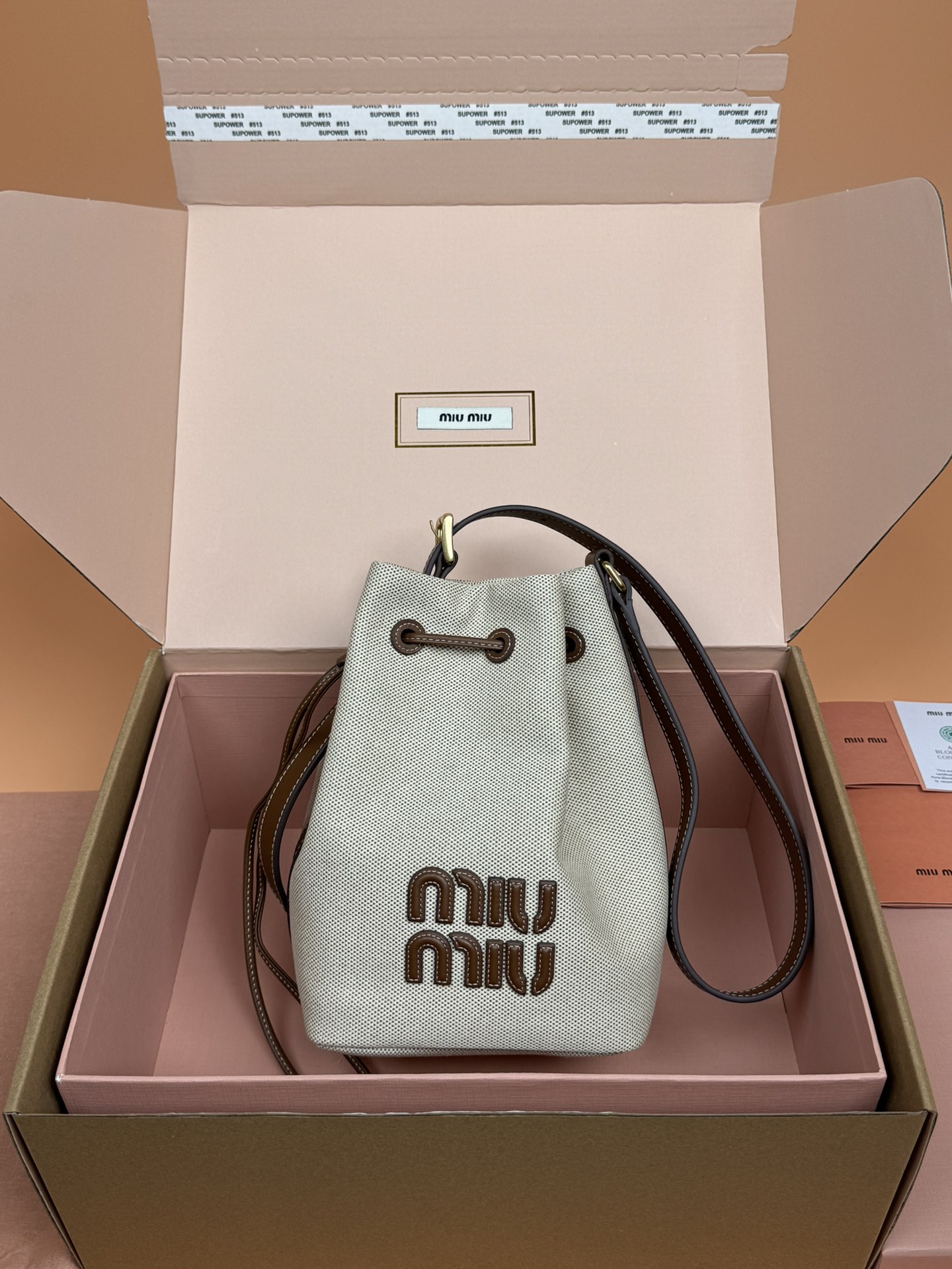 NO:185009,[Original leather of special hardware] Canvas and cowhide leather bucket bag ~ White cloth [Small] This bucket bag is intertwined with contrasting materials and colors, highlighting its independent design. The letter logo adds a unique personality to the design of the handbag. ~Adjustable handle ~Gold-plated hardware accessories ~Bond letter logo ~Drawstring opening and closing ~Line Size: W14×H22.5×D16cm Number_5BE, Special Miu Miao, cowhide, gold plating19860909【特级五金原厂皮】 帆布与牛皮革水桶包～白布【小号】 这款水桶包以对比鲜明的材料和颜色相互交织,彰显出其独立的设计.字母徽标为手提包的设计增添了独特的个性. ～可调式提手 ～镀金色五金配件 ～正面字母徽标 ～抽绳开合 ～带衬里 尺寸:W14×H22.5×D16cm 編號_5BE,特级缪缪,cowhide,gold plating,Bag