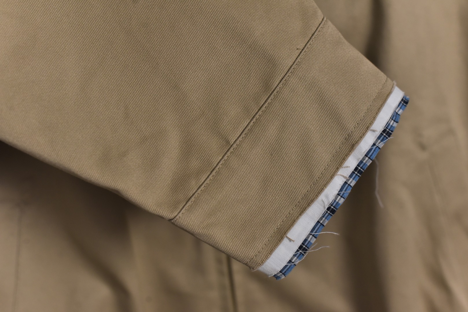 图片[7]-#Miu Miu 25Fw Miu贴布绣格纹假两件夹克外套 定织定染高支数斜纹纺织，赋予面料硬挺的骨骼感与细腻的肌理触感。斜纹结构确保抗皱性与耐久度，同时通过微光泽后整理提升表面质感，呼应现代都市机能美学，选用19姆米级丝绸混纺内衬，以静电覆合技术贴合主体面料，实现无缝一体结构。丝质内里不仅提供亲肤透气性，更通过对比光泽强化内外层次差异，暗藏低调奢华感，复合式拼接设计，领口、袖口采用蓝格纹拼接设计，通过激光裁切包边工艺实现精准对格。拼接部位以隐藏式埋夹缝制衔接，边缘做0.3cm仿旧毛边处理，模拟自然磨损的复古效果，同时与主面料形成粗犷与精致的材质对话，定制镀金色五金拉链，选用日本YKK EXCELL系列底链，齿牙经PVD真空镀金处理，达到3级耐磨标准。拉头内部嵌入硅胶减震垫片，实现静音开合，表面做做旧蚀刻工艺呈现斑驳肌理，避免工业感过强，每颗纽扣取材于水牛角切片，经手工抛光保留天然纹理与半透光特性缠绕同色系绣线防止脱落，细节体现传统工艺与现代设计的融合 尺码：S-L【不拉拉链可以不用考虑体重】-选品中心