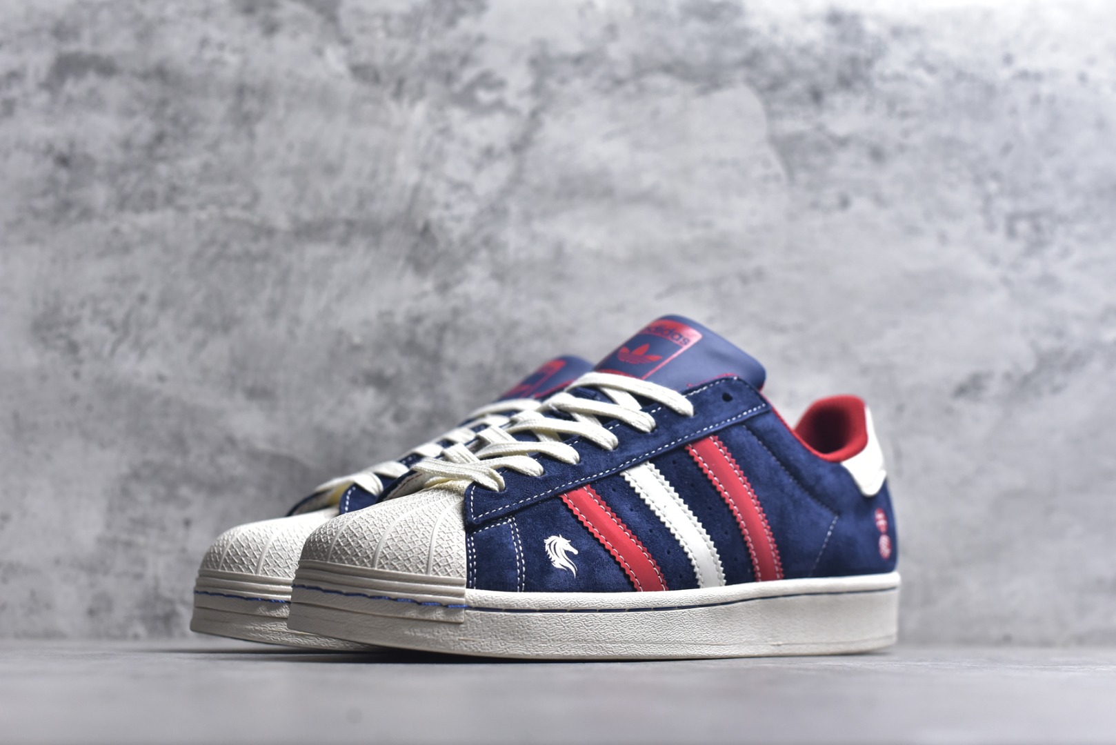 图片[2]-#经典贝壳 马年焕新ADIDAS SUPERSTAR 藏蓝翻毛皮质感升级，红白撞色三条纹活力吸睛，鞋侧骏马刺绣与“千马”印章暗藏新年巧思。贝壳头设计延续街头基因，软弹橡胶底适配日常穿搭，既是复古潮人的情怀之选，也是春节走亲访友的吸睛利器。 货号：JY8925 尺码：36 36.5 37.5 38 38.5 39 40 40.5 41 42 42.5 43 44 44.5 45-选品中心