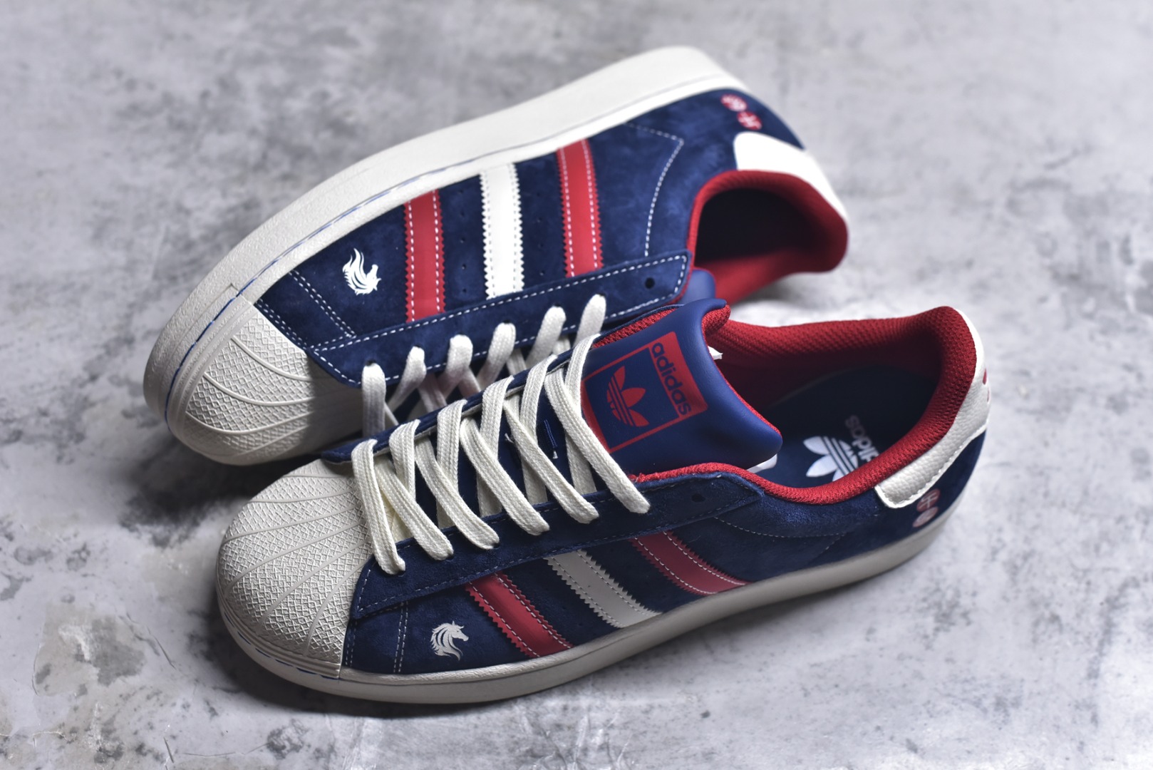 图片[7]-#经典贝壳 马年焕新ADIDAS SUPERSTAR 藏蓝翻毛皮质感升级，红白撞色三条纹活力吸睛，鞋侧骏马刺绣与“千马”印章暗藏新年巧思。贝壳头设计延续街头基因，软弹橡胶底适配日常穿搭，既是复古潮人的情怀之选，也是春节走亲访友的吸睛利器。 货号：JY8925 尺码：36 36.5 37.5 38 38.5 39 40 40.5 41 42 42.5 43 44 44.5 45-选品中心