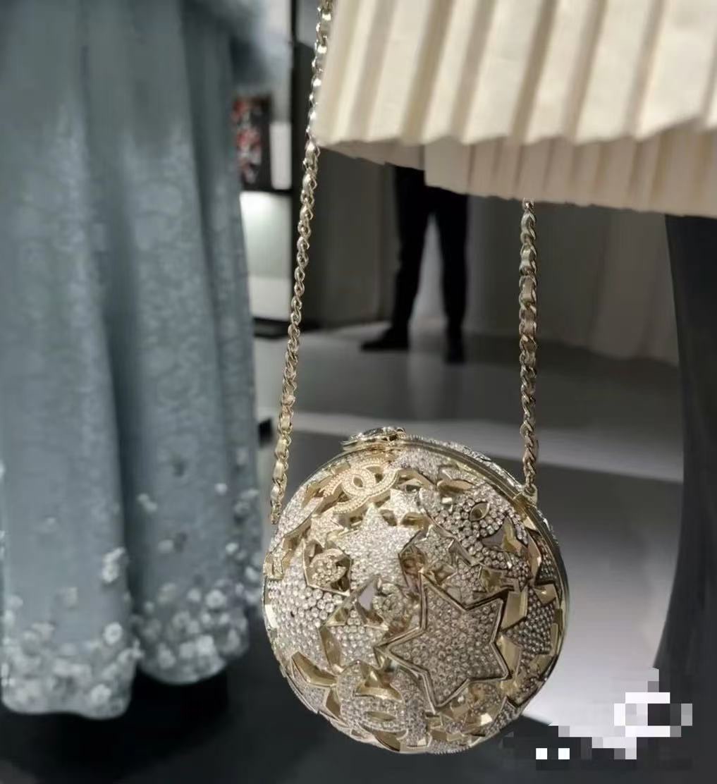 NO:700784,OHANEL 25A high-end handmade five-pointed star-shaped dinner bag series. The star-shaped hollow ball-shaped dinner bag is so amazing [Celebrate] [Celebrate] Z-level, the top manufacturer in the industry produces a star-shaped hollow ball-shaped dinner bag, and it is another must-have small crystal gold ball for collectors. The whole ball is made of ten pairs of five-pointed stars C  Composed of logo, the hollow design is inlaid with diamonds, full of details, exquisite and elegant, the hollow design is unique and beautiful. Material: all copper hardware and imported rhinestones. Size: 13x13x13cm. Collector19860909出货啦OHANEL 25A高级手工坊五角星球形晚宴包系列星星镂空球形晚宴包太惊艳啦[庆祝][庆祝]Z级,行业顶级厂家出品星星镂空球形晚宴包,又又又是一枚收藏家系列必入水晶小金球,整个球是由五角星十双C Logo组成,镂空设计镶嵌着钻石,细节感满满,精致高雅有质感,镂空设计独特美观材质:全铜五金十进口水钻尺寸:13x13x13cm,收藏家,韩剧