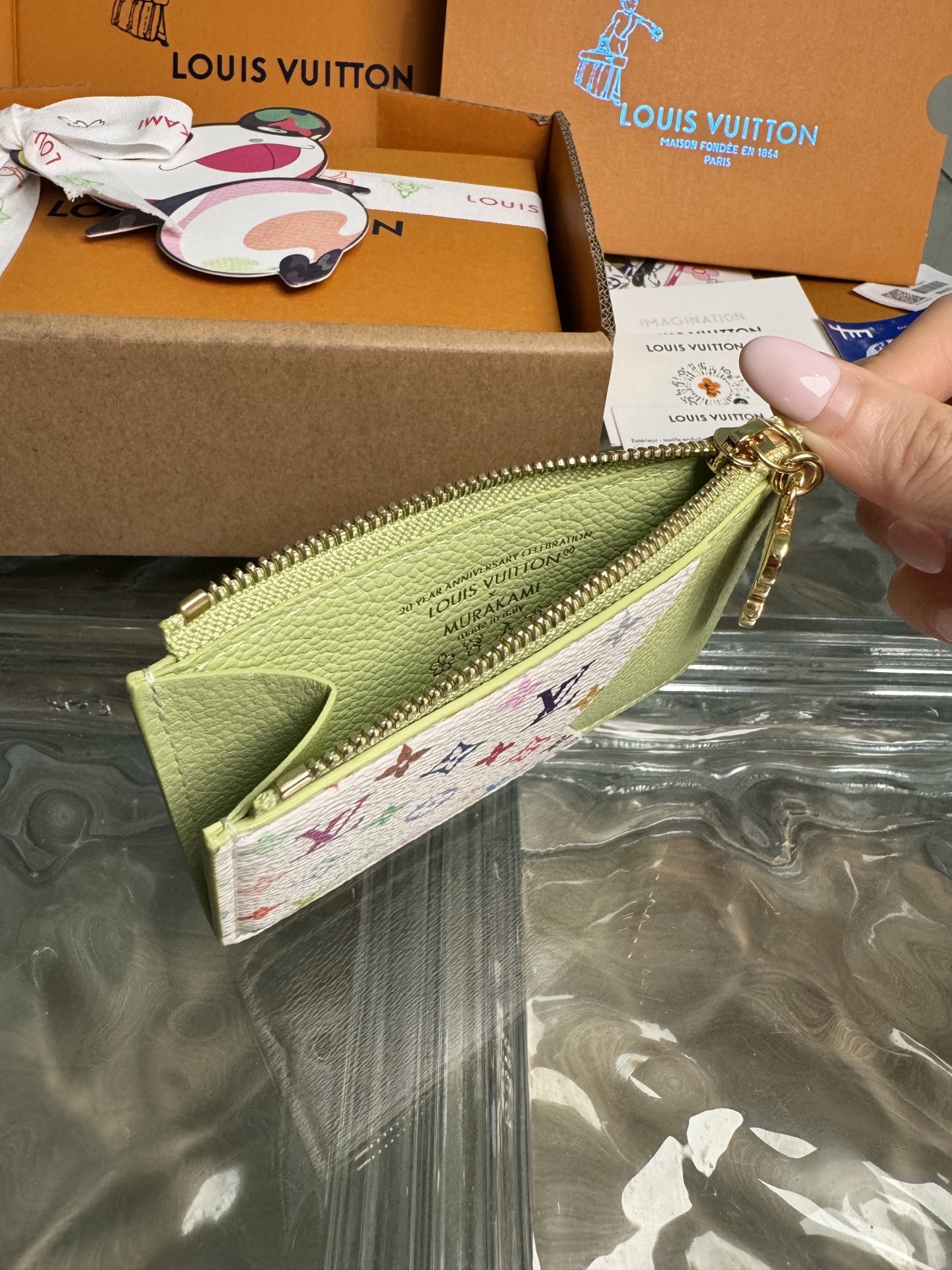 p320。M13800【官方全钢芯片版163c01】
作为跨类别路易威登x村上隆系列的一部分，Romy卡片夹既实用又充满趣味，采用清新色彩，灵感源自这位日本艺术家惯用的彩虹调色板。它巧妙地在整个 Monogram Empreinte皮革上签名，而平口袋则用多色Monogram涂层帆布鲜艳地突出显示。硬币口袋用金色拉链固定，拉链边缘装饰有熊猫形状的拉头，作为最后的季节性点缀。12x8x0.8cm 
