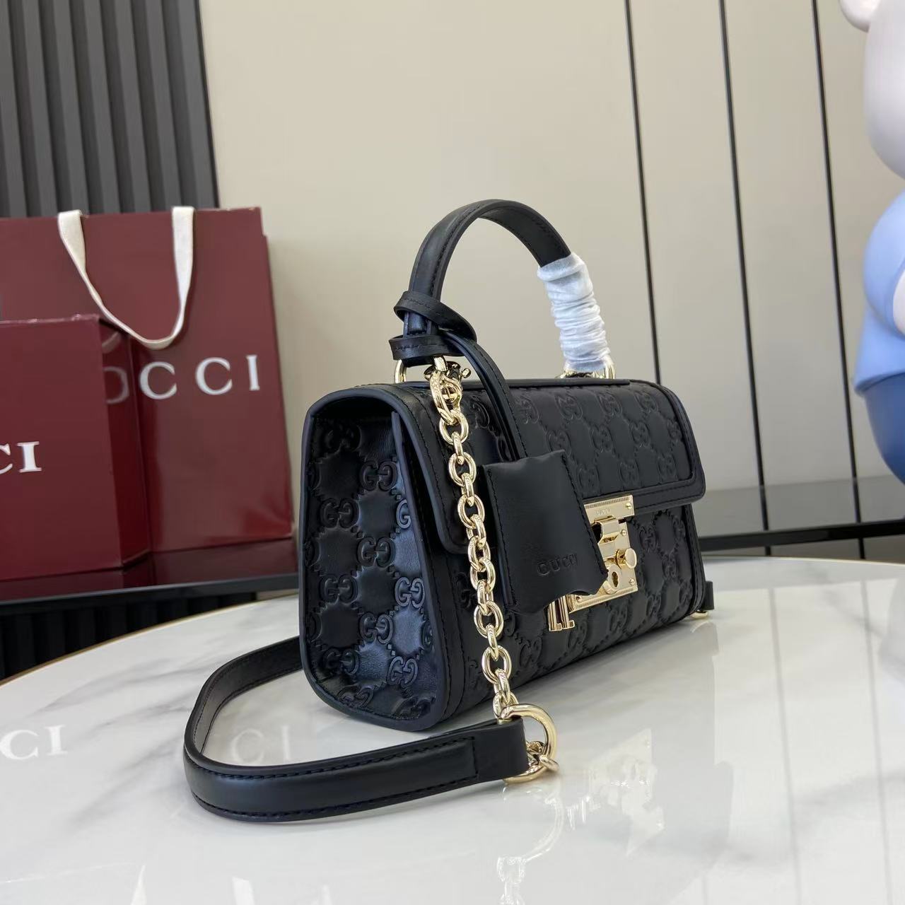 p640。《配全套原厂专柜包装》【新品】Padlock系列以现代廓形惊艳亮相2025早秋系列，解锁多种背携方式。此款式手提或斜挎皆宜，织带衬里致敬品牌标志性元素。
黑色GG字母交织图案涂层织物
黑色皮革滚边
浅金色调配件
黑色棉布衬里
内部：一个开口袋
外部：一个开口袋
提手（6厘米高）
可拆卸可调节皮革肩带（高度：57厘米 – 62厘米；长度：103厘米 – 123厘米）
挂锁锁扣，配有皮革钥匙扣
型号：848884。
尺寸：20厘米（宽）x 13厘米（高）x 8厘米（深）
重量：约0.6千克
颜色：黑色/压花。
意大利创作
