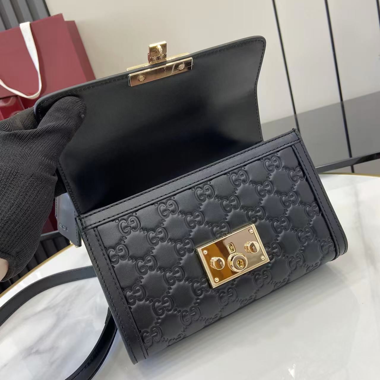 p640。《配全套原厂专柜包装》【新品】Padlock系列以现代廓形惊艳亮相2025早秋系列，解锁多种背携方式。此款式手提或斜挎皆宜，织带衬里致敬品牌标志性元素。
黑色GG字母交织图案涂层织物
黑色皮革滚边
浅金色调配件
黑色棉布衬里
内部：一个开口袋
外部：一个开口袋
提手（6厘米高）
可拆卸可调节皮革肩带（高度：57厘米 – 62厘米；长度：103厘米 – 123厘米）
挂锁锁扣，配有皮革钥匙扣
型号：848884。
尺寸：20厘米（宽）x 13厘米（高）x 8厘米（深）
重量：约0.6千克
颜色：黑色/压花。
意大利创作
