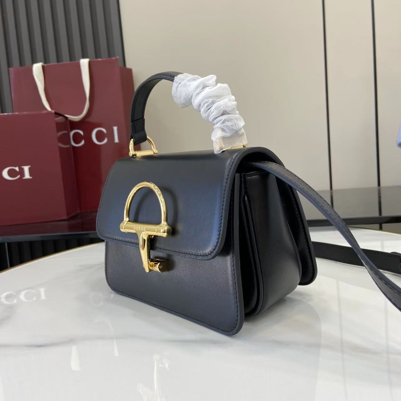 p750。《配全套原厂专柜包装》Gucci Siena系列焕新演绎品牌经典马衔扣元素，打造魅力手袋单品。这款手提包选用精细光面皮革匠心打造，挺括造型融蕴源自20世纪70年代的半马衔扣搭扣设计细节
黑色光面皮革
金色调配件
黑色皮革衬里
内部：3层接档，1个开口口袋
提手（6.5厘米高）
可拆卸可调节皮革肩带（高度：45厘米；长度：43厘米 - 47厘米）
半马衔扣造型按扣
型号：855536。
尺寸：19厘米（宽）x 13厘米（高）x 8.5厘米（深）
重量：约0.5千克
颜色：黑色全皮。