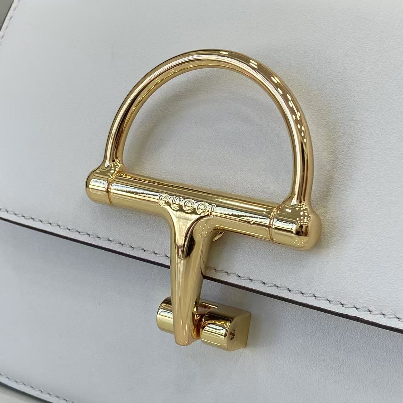 p750。《配全套原厂专柜包装》Gucci Siena系列焕新演绎品牌经典马衔扣元素，打造魅力手袋单品。这款手提包选用精细光面皮革匠心打造，挺括造型融蕴源自20世纪70年代的半马衔扣搭扣设计细节
白色光面皮革
金色调配件
白色皮革衬里
内部：3层接档，1个开口口袋
提手（6.5厘米高）
可拆卸可调节皮革肩带（高度：45厘米；长度：43厘米 - 47厘米）
半马衔扣造型按扣
型号：855536。
尺寸：19厘米（宽）x 13厘米（高）x 8.5厘米（深）
重量：约0.5千克
颜色：白色全皮。