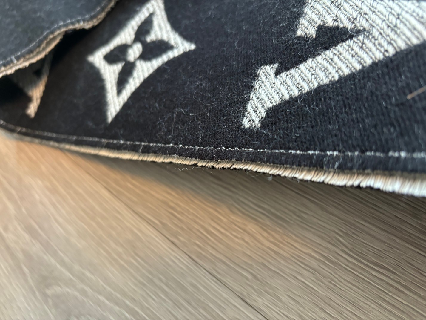 Detailed craftsmanship reveals precise, dense, and uniform edge-stitchin - Scarf