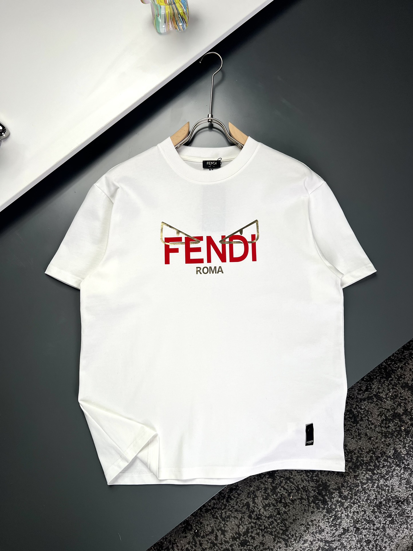 NO:125347,FENDI*Fendi long shoulders, wide bust and sleeves S714911022 M735011423 L755111624 XL775212225 Recommended size S/100-120M/ 120-140L/140-160XL/ 160-180 Fluorescent letter printed short-sleeved T-shirt *Selected 290g 26 double yarns tight-spun fabric, both breathability and comfort, wear resistance and texture coexist. Every time you wear it, it is a gentle care for the skin. *Unique logo design, blending metal powder and printing technology, not only has rich visual appearance, but also shows a unique texture under light and shadow. Every time you wear it, it is carefully carved for details. *With its unique design, it has created a classic work in the fashion industry.  Showing a unique personality and style can make you the focus whether it is going to work, date or party. It is not only a fashionable item, but also an excellent choice to show your personality and taste!  Washing method is recommended to dry cleaning or wrap the back of the laundry bag. It is recommended to quickly machine-wash and dry naturally when it is cold water on the back!  Men and women model number XL1142 White Black S-Xl,,fendi,fendi,T-shirt,tees,t-shirt,alexander wang19860909FENDI*芬迪 衣长肩宽胸围袖长 S714911022 M735011423 L755111624 XL775212225 推荐尺寸 S/100-120M/ 120-140L/140-160XL/ 160-180 荧光字母印花短袖T恤 *精选290g 26支双纱紧密纺面料,透气性与舒适度兼备,耐磨性与质感并存.每一次穿着,都是对肌肤的温柔呵护. *独特logo设计,融合金粉与印花工艺,不仅视觉丰富,更在光影下展现出独特的质感.每一次穿着,都是对细节的精心雕琢. *以其独特的设计,造就了时尚界的经典之作. 展现出独特的个性与风格,无论是上班、约会还是聚会,都能让你成为焦点.它不仅是一件时尚单品,更是展现个性和品味的绝佳选择！ 洗涤方式建议干洗或包裹洗衣袋反面单独冷水快速机洗自然晾干！ 男女同款 款号XL1142 白色 黑色 S-Xl,,fendi,fendi,T-shirt,tees，t-shirt,alexander wang,Men's clothing