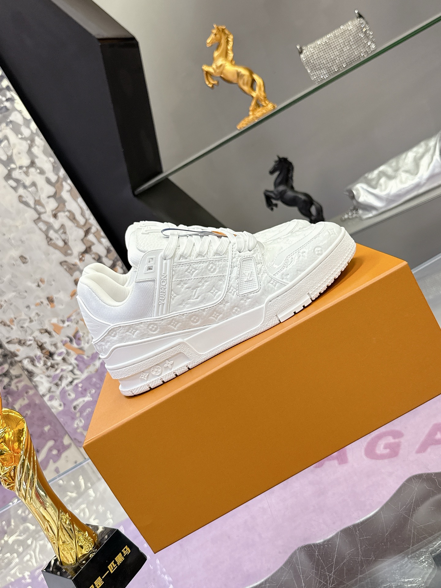 Louis Vuitton 本款LV Trainer运动鞋为亮泽漆面牛皮革压印迷你Monogram图案