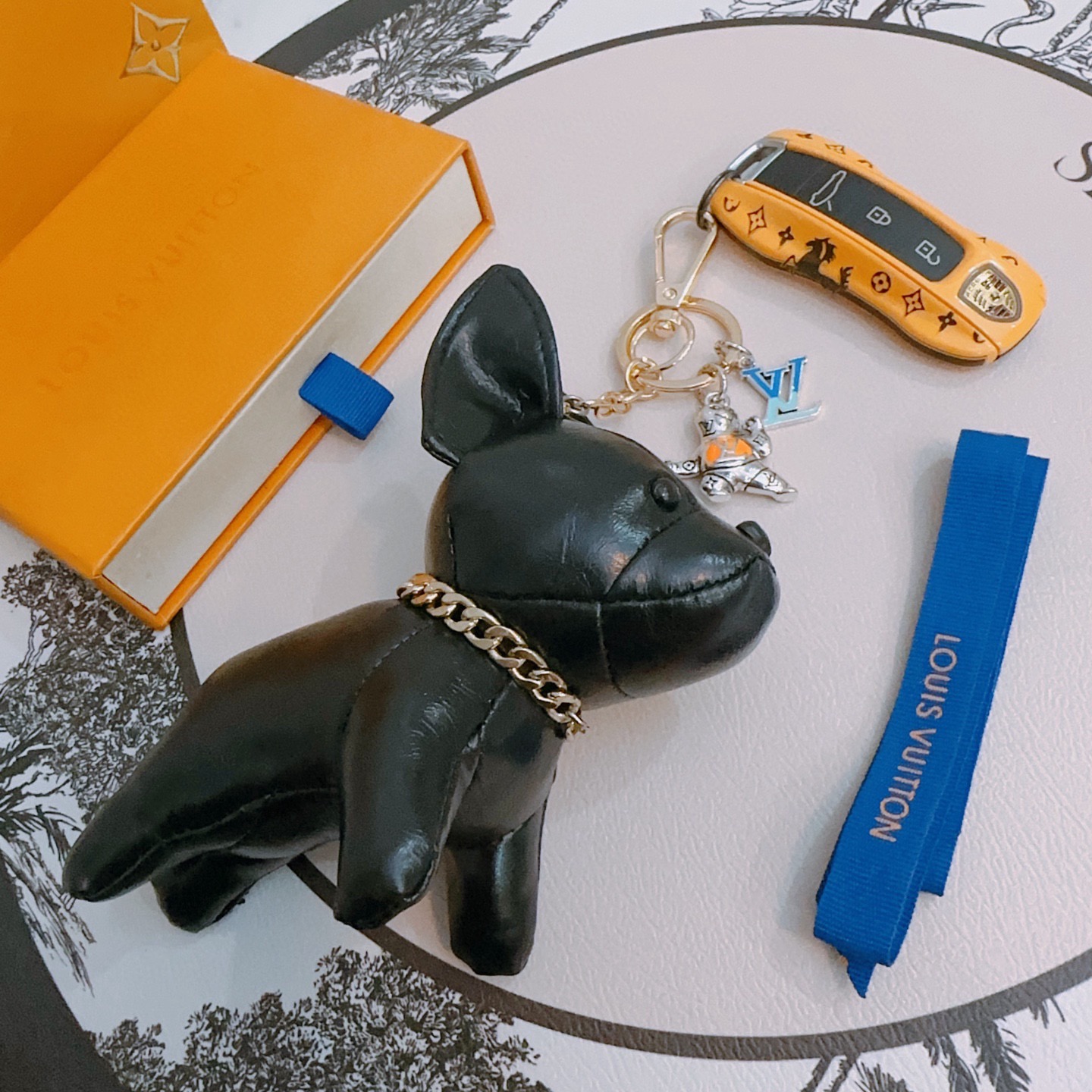 Louis Vuitton Anger Forest French Bulldog Keychain pendant black leather gold-tone metal silver-tone metal with orange and blue enamel accents 12cm plush charm with 5cm key ring