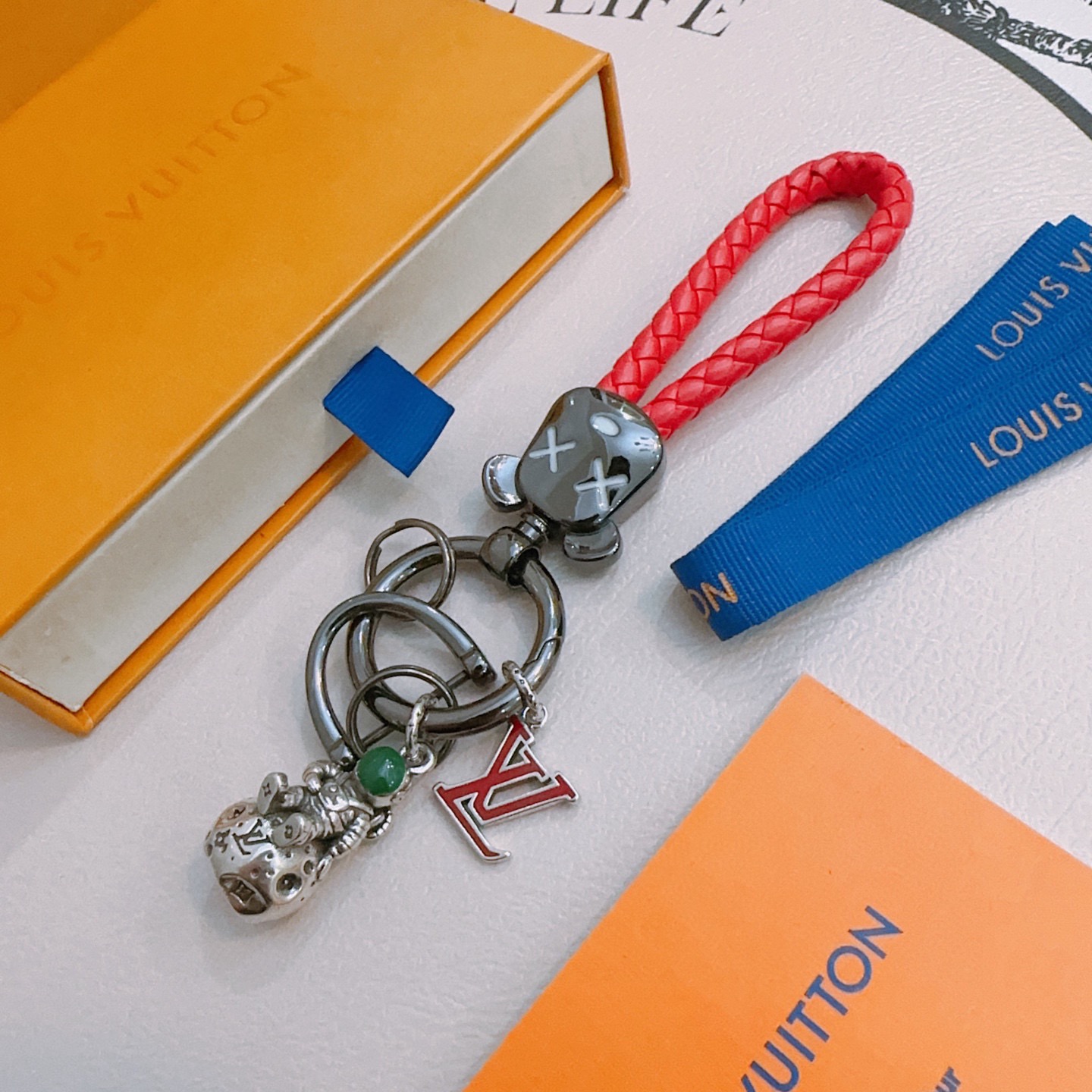 Louis Vuitton Anger Forest Astronaut Bear Keychain pendant Gunmetal gray metal red braided leather silver-toned charm green stone accent red enamel LV logo 12cm total length