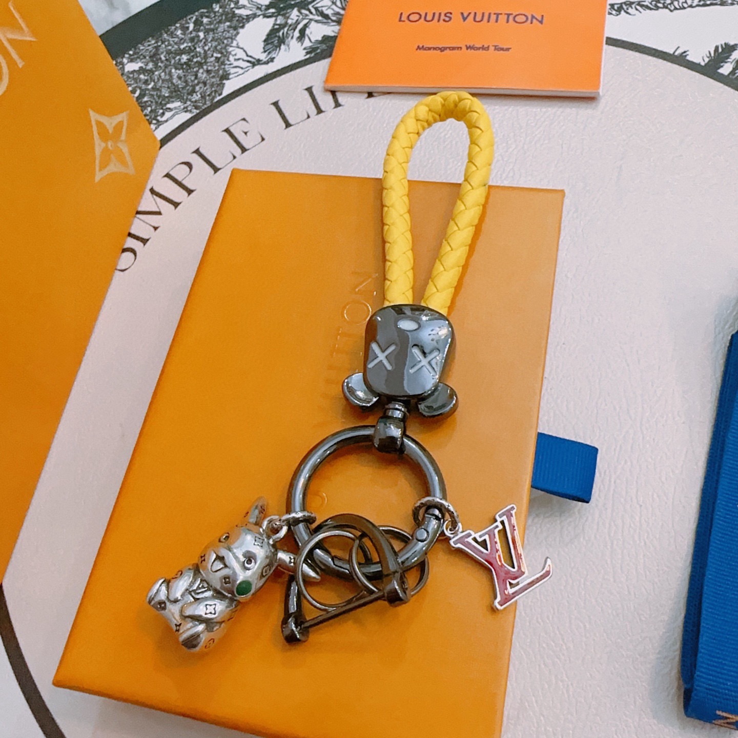 Louis Vuitton Anger Forest Keychain pendant Yellow braided leather gunmetal hardware silver bull charm with green enamel detail red enamel LV logo charm 10cm