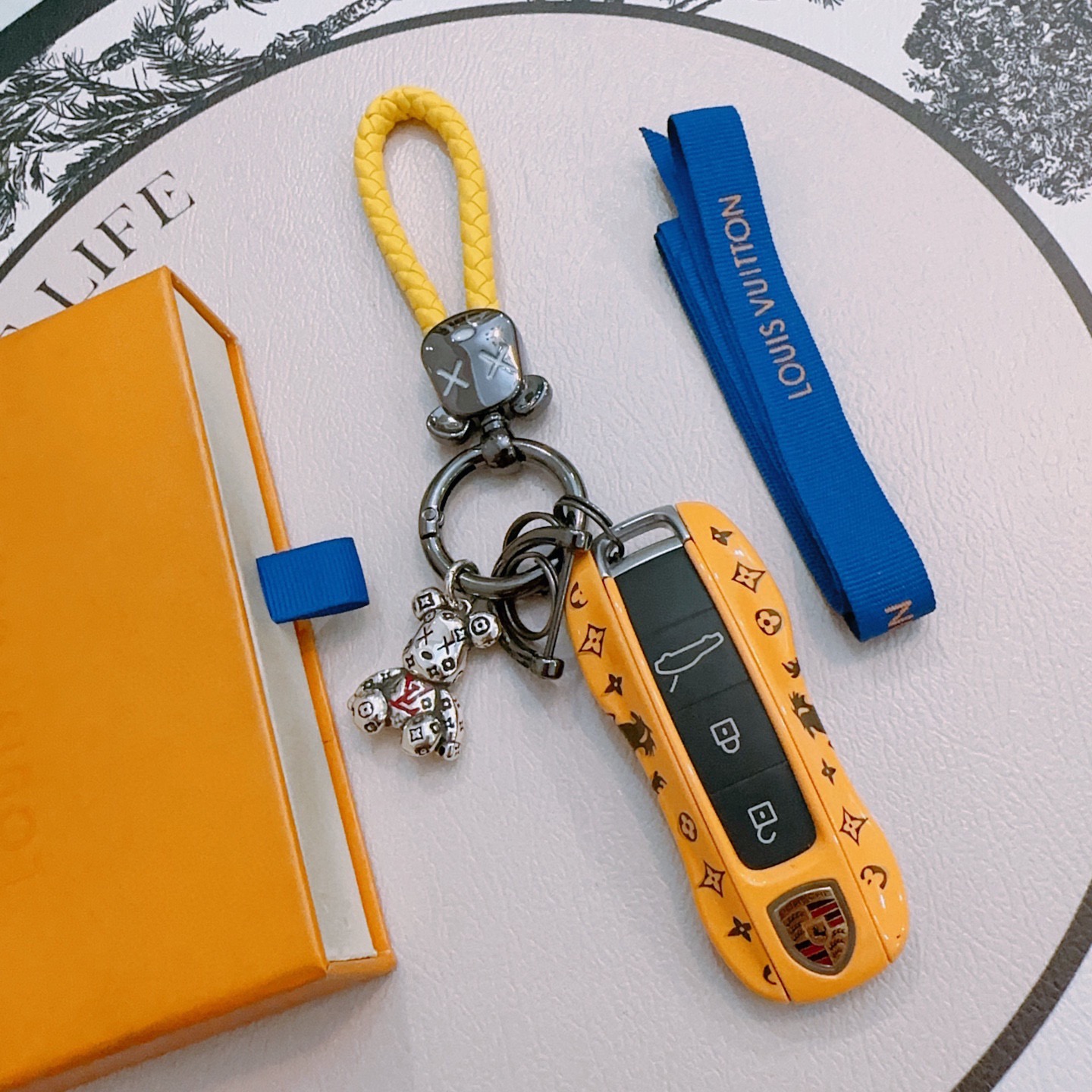 Louis Vuitton Anger Forest Bear Keychain pendant Gunmetal gray metal bright yellow braided leather silver-tone bear charm with red LV accent and black monogram detailing 12cm total length