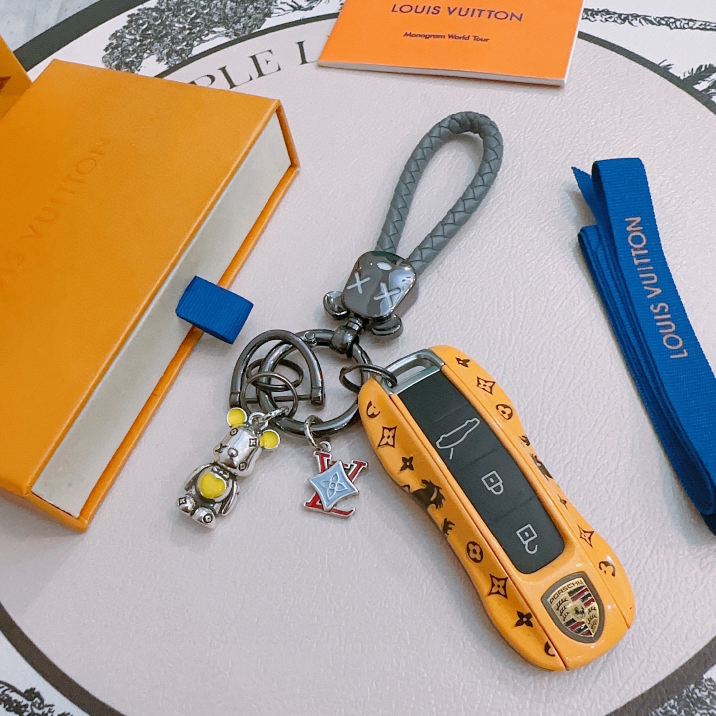 Louis Vuitton Anger Forest Bear Keychain Charm pendant Gunmetal gray hardware gray braided leather strap silver-tone bear charm with yellow enamel accents red and light blue enamel LV monogram charm 12cm total length