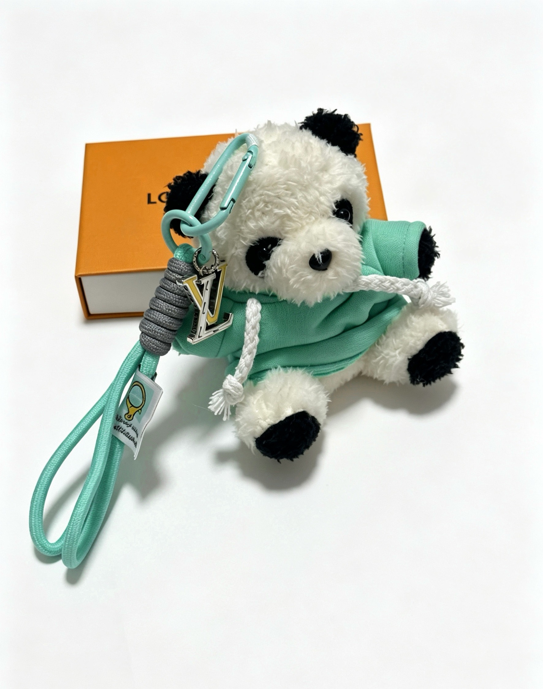 Louis Vuitton Anger Forest Panda Charm Keychain pendant Mint green cord gray wrapped cord silver-tone metal with gold LV logo white and black plush panda with mint green hoodie 12cm total length with 8cm wrist strap