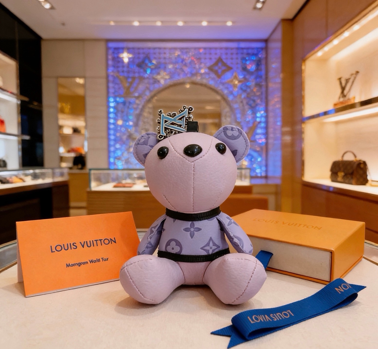 Louis Vuitton Anger Forest Bear Charm pendant Light purple leather with lavender monogram print silver-tone metal with light blue enamel LV logo black plastic eyes and nose black fabric trim blue fabric strap 12cm