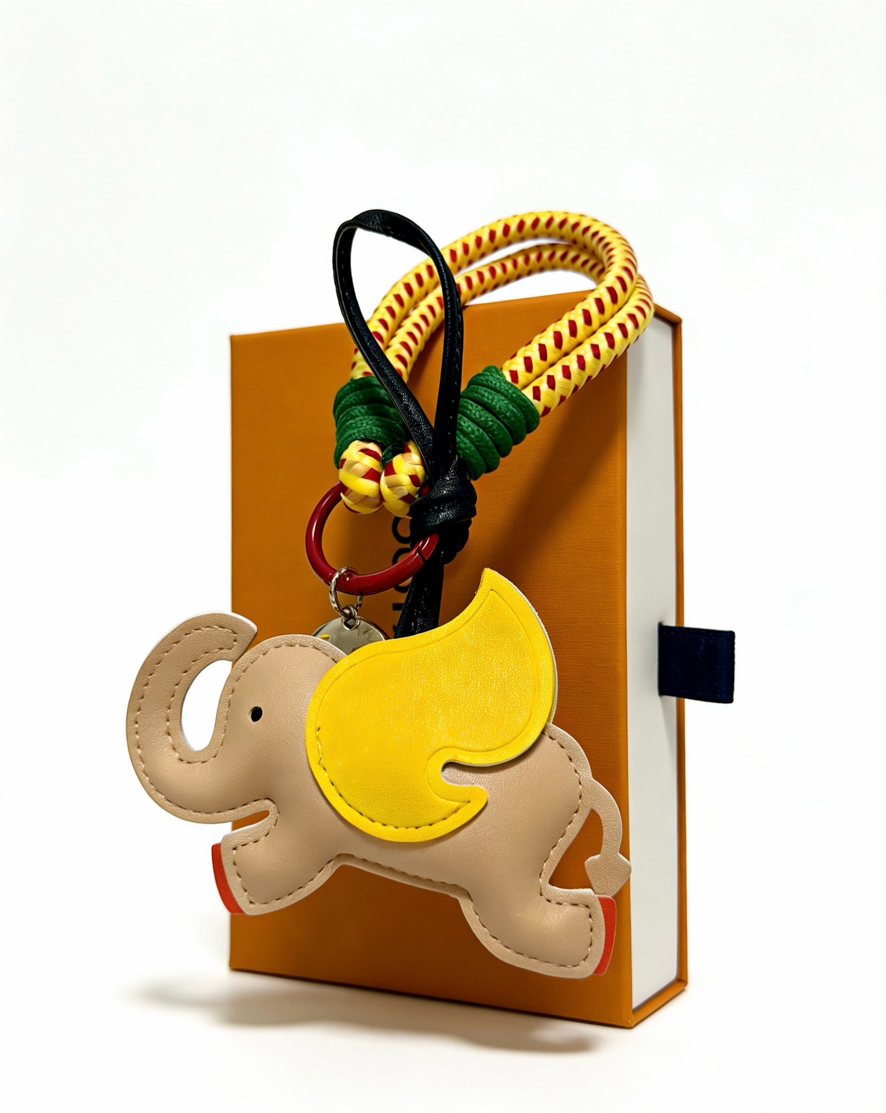 Louis Vuitton Anger Forest Elephant Charm Keychain pendant Beige leather with yellow leather ear red painted feet yellow and red braided cord green cord wrap black leather strap red enamel metal ring silver-tone metal with yellow LV logo charm 18cm strap length
