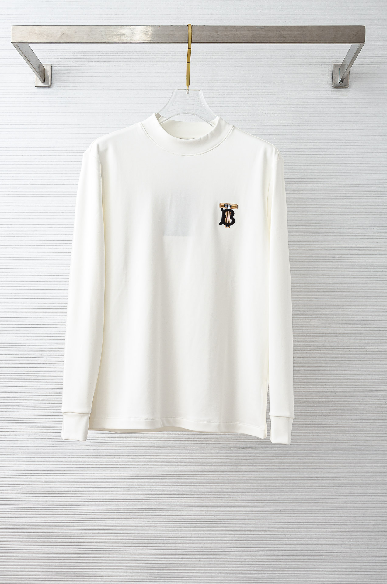 NO:606779,BBR Burberry's new 25FW autumn and winter three-dimensional embroidered men's long-sleeved T-shirt # focuses on the fabric. The fine grid texture clearly visible on the surface is enough to highlight its high-end texture. It is wear-resistant and anti-wrinkle and has good drape. It supports the shape of the entire shirt perfectly!  Breathability and convenience are of course not to mention, and it also has a certain degree of wrinkle resistance and stain resistance, which greatly reduces the convenience of daily care and storage. The soft, gentle but crisp gold fabric, and after the texture combination of the fabric itself, will slightly show different colors and textures under different lights.  The feel allows you to be versatile and easily adapt to various occasions. The whole dress is simple and clean, with a fit and crisp fit, and an excellent wearing effect. And the inside is designed with velvet, which has a delicate touch and warm care for you in autumn and winter. It is warm and wind-resistant. Whether worn alone or layered, it is a very versatile and practical style!  The classic straight version has a good effect on the upper body, and is classic and versatile. The classic embroidery details on the chest are embellished. I believe that you who have taste will be familiar with it!  Every detail is made with exquisite care and is a test of craftsmanship. Whether it is fabric cutting or craftsmanship, it fully embodies the brand's century-old history and skilled garment production technology. It is perfect in every aspect, with no flaws. The style is fashionable and versatile, and it can be used between leisure and business with ease. It is a must-have for quality control people.  Color Black/White Size S-XXL,,burberry,shirts,tees,t-shirt,gold,alexander wang19860909BBR巴宝莉 25FW秋冬新款 立体刺绣男士长袖T恤衫#把重心都放在了面料上,表面清晰可见的细格肌理,足以凸显出它的高级质感,耐磨抗皱垂感佳,将整件衬衫版型承托的极其完美！透气性跟便捷性自然不在话下,还具有一定的抗皱性与耐脏度,大大减少了日常中的打理与保存便捷性.柔软温和却挺括的黄金面料,并且经过面料本身的纹理组合之后,在不同光线下会轻微显现出不一样的色泽跟质感,让你百变多样轻松应对各种场合.整件衣服都简洁干净,版型服帖挺括,穿着效果极佳.并且内里做了加绒的设计,细腻触感温暖呵护秋冬季节的您,保暖抗风,不管是单穿还是内搭都是非常百搭又实穿的款式！ 经典的直筒版型上身效果好,同时经典百搭,胸前经典刺绣细节点缀,相信有品味的你们一定不会陌生！每一处细节都做的非常的精湛考究,极其考验工艺技巧,无论是从面料裁剪还是工艺制作都完全体现了品牌百年的深厚历史以及娴熟的成衣制作工艺,不管是从哪一个方面看都完美到极致,毫无缺点,风格时尚百搭,休闲商务之间游刃有余,品控族必入的类型,可遇而不可求！ 颜色黑色/白色 尺码S-XXL,,burberry,shirts,tees，t-shirt,gold,alexander wang,Men's clothing
