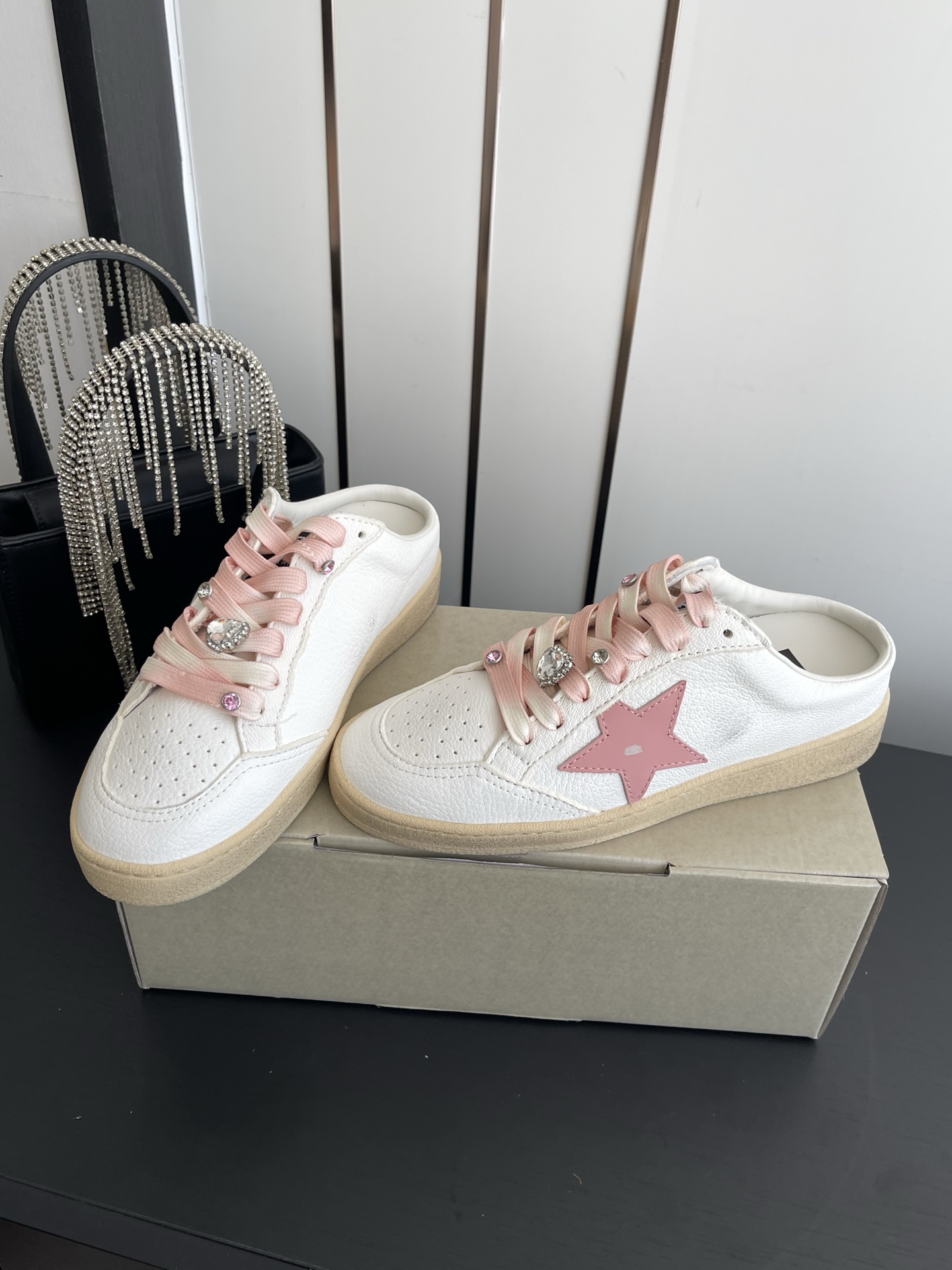 Alexander McQueen 这双半拖小白鞋以软乎乎的奶白鞋身搭配粉色星星图案 自带甜妹氛围感 渐变鞋带搭配爱心水钻饰扣