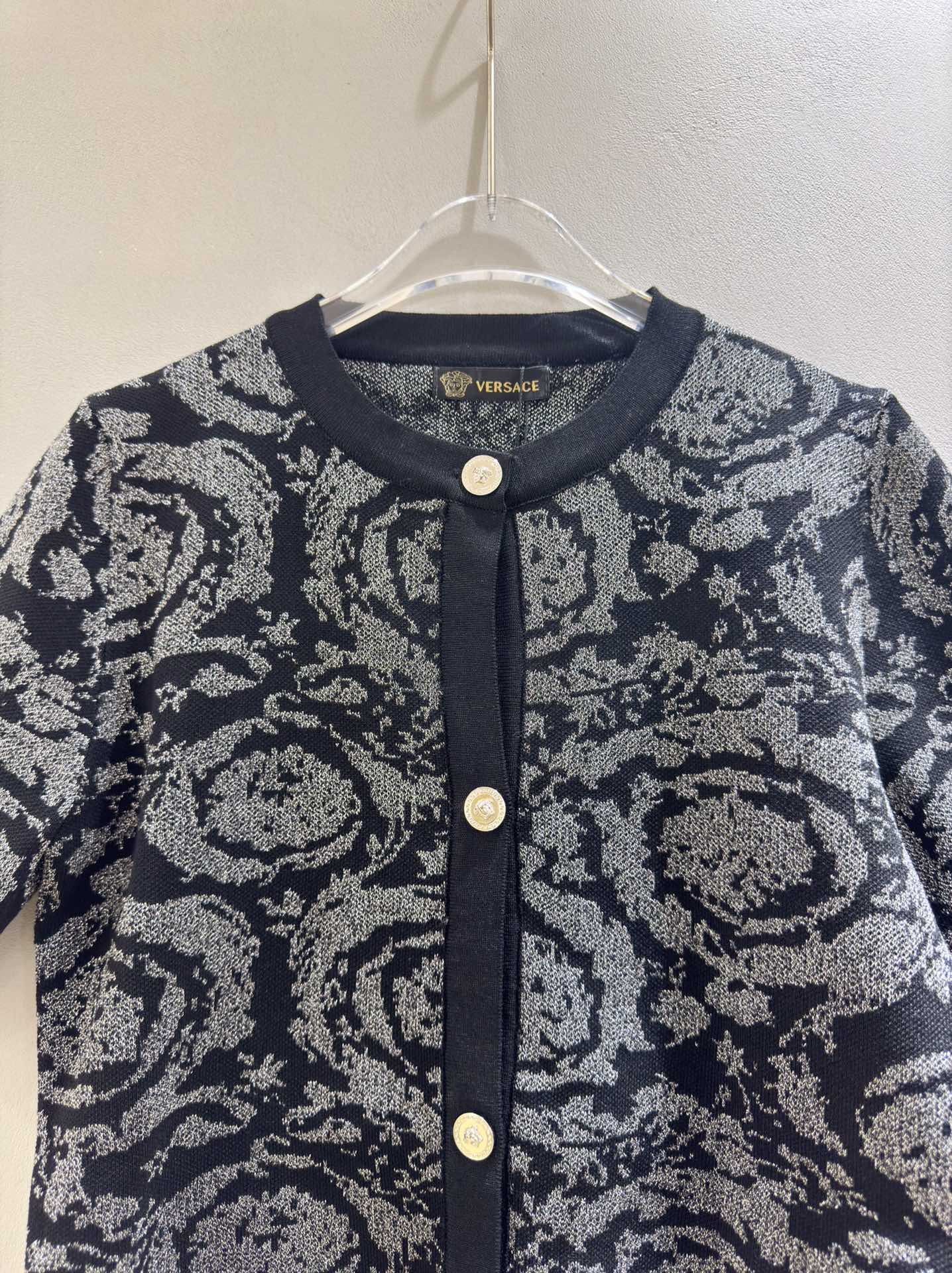 Versace black short sleeve knit cardigan with color block print and shimmer.-Big cat