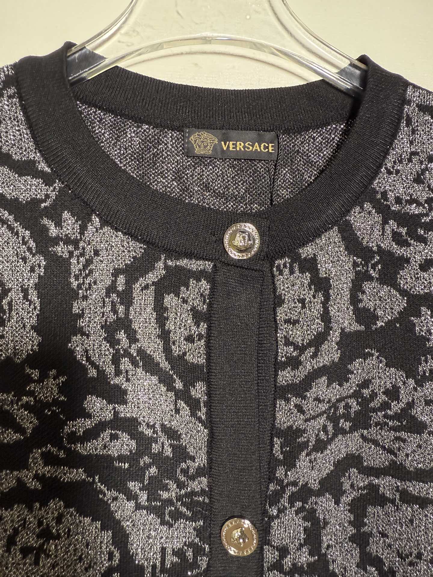 Versace black short sleeve knit cardigan with color block print and shimmer.-Big cat