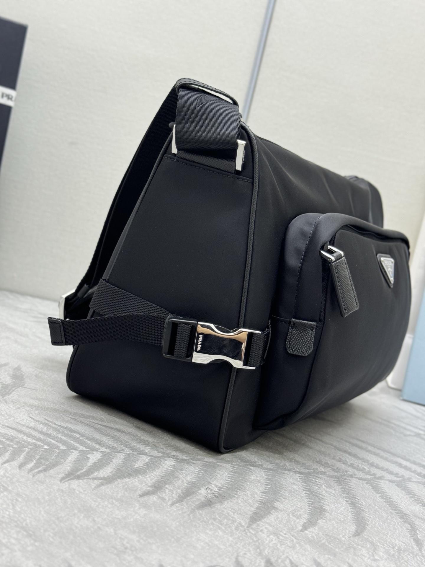 P410，🎉新款大号邮差包🎉🎉2VH191大号🎉🎉
这款单肩包的运动功能性由简约线条和实用现代细节定义。包身采用创新性的Re-Nylon再生尼龙材质打造，搭配Saffiano牛皮革细节，增添独特精致气息。多功能风格融合标志性元素，饰以涂珐琅金属三角形徽标，容量空间大，又是一款永久不过时爆款，赶紧入手吧🎉🎉
尺寸:长35x高22x底12cm(此款大，不配包装)