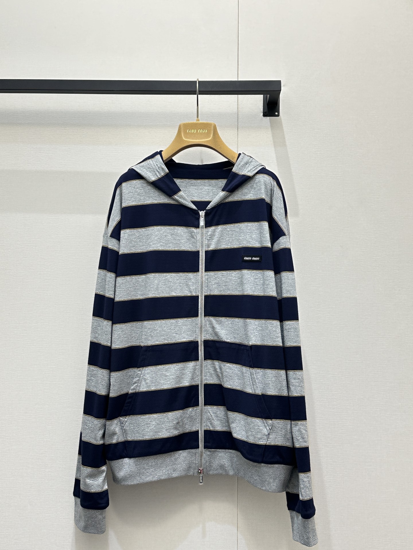 NO:736746,Miumi* 26Ss early spring new micro-label striped zipper hooded sweatshirt jacket丨Exclusively developed!  Top quality production!  The classic stripes of navy blue and heather gray collide to outline a frank and sweet modern silhouette. The custom-made high-count cotton blended fabric is soft to the skin, with both airiness and stiffness. The loose shoulder cut is suitable for various body shapes, and can freely unlock a lazy and casual wearing posture. The mini logo embroidery on the side of the body is low  The design is engraved with the brand identity, and the delicate metal zipper extends along the striped texture, becoming the visual focus and making putting on and taking off more ritualistic. Available in stock, S/M/L, large quantities, real shots,, miumiu, hoodie, sweatshirts, jackets  & coats,hats,19860909Miumi* 26Ss早春新款 微标条纹拉链连帽卫衣外套丨独家开发！顶级高版出品！以藏青与麻灰的经典条纹碰撞,勾勒出率性又甜美的摩登轮廓.定制高支棉混纺面料触肤柔软,兼具空气感与挺括度,宽松落肩剪裁适配多元身形,自在解锁慵懒随性的穿搭姿态.衣身侧边的迷你徽标刺绣低调镌刻品牌身份,细巧的金属拉链顺着条纹肌理延伸,成为视觉焦点的同时,也让穿脱更具仪式感.现货发售S/M/L大货实拍,,miumiu,hoodie,sweatshirts,jackets & coats,hats,,Women's clothing