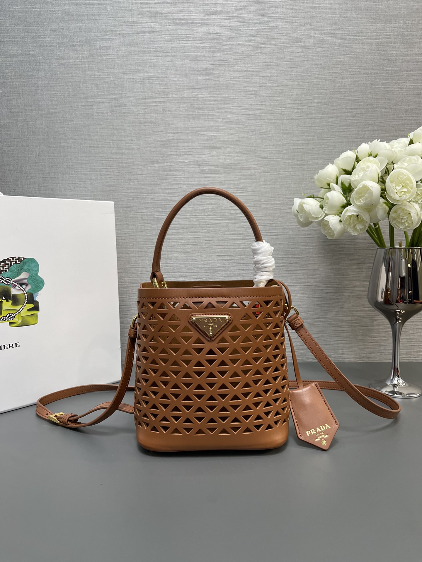 NO:178988,Genuine grade original leather P home new 217 hollow full bucket water leather bag 1BA217 is here. The popular 