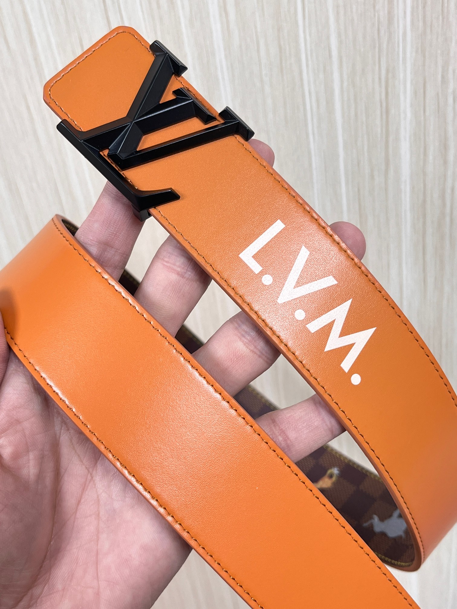 本款 LV Initiales 40 毫米双面腰带以电影叙事为灵感，气质颇具神秘魅力。Damier 格纹