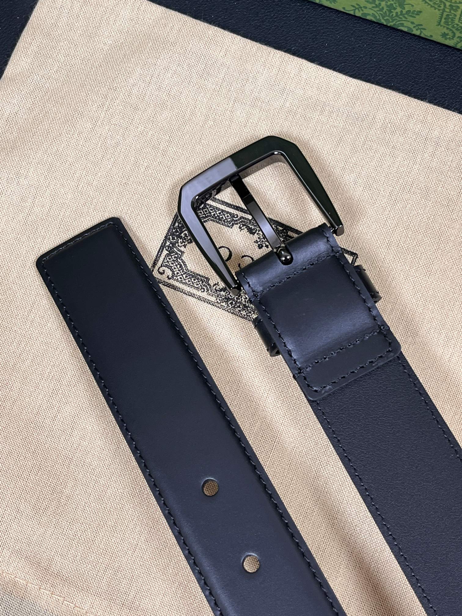 当季新款，中性色调精致牛皮革与方形搭扣完美合璧，不经意间散发商务正装风范。这款宽版腰带精选光面牛皮革制作