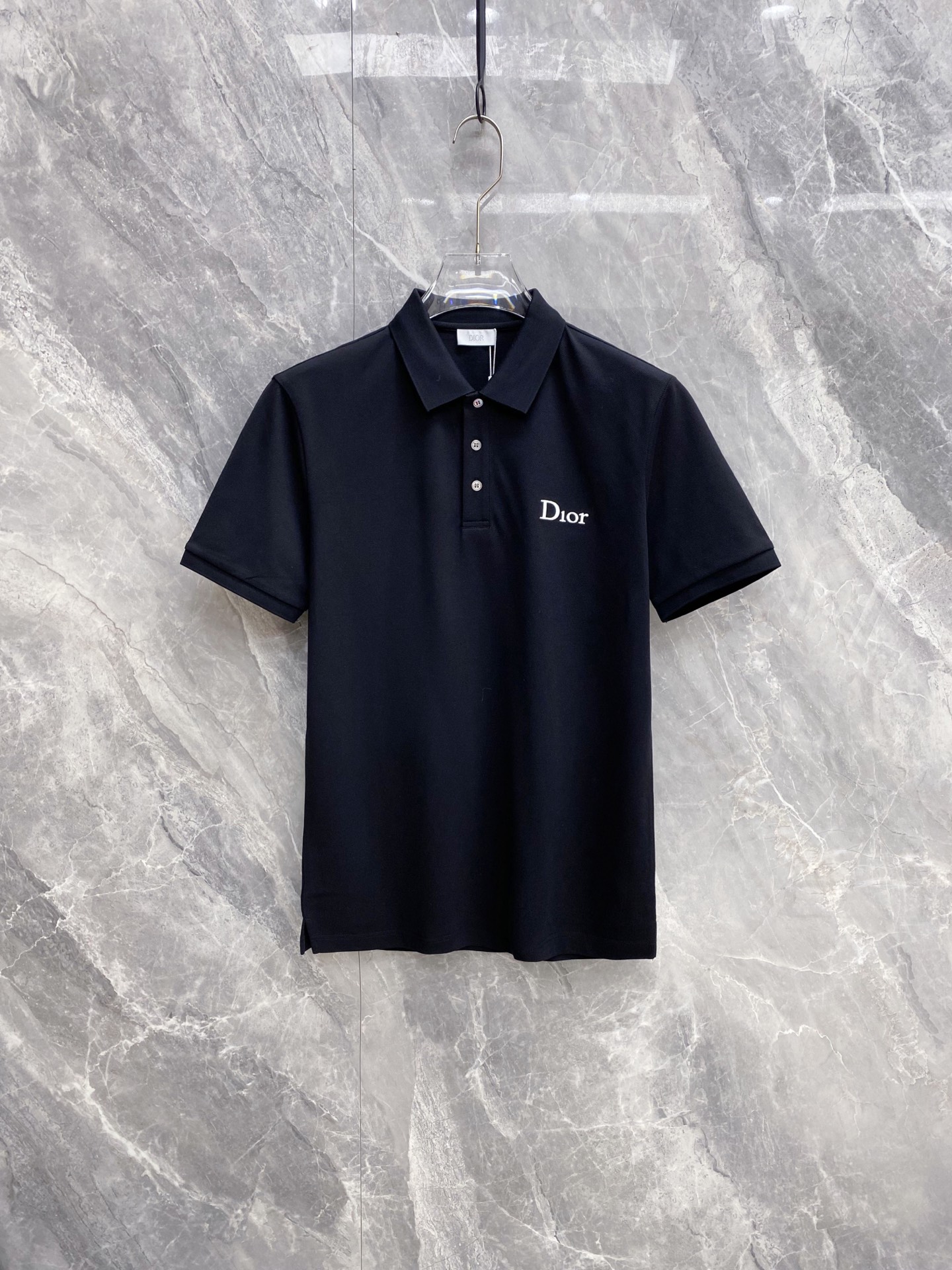 NO:861094,Dior Dior 2026 Spring and Summer New Style | Dior Classic Logo Polo Shirt is made of high-density piqué cotton fabric, breathable and dry, perfect for the hot weather in spring and summer. The neat lapels are matched with a three-button placket, the fit is crisp but not soft; the exquisite brand embroidery on the chest low-key releases the brand texture. The black and white two-color classic and versatile, whether it is commuting or daily leisure, you can easily create a simple and high-end urban outfit. It is a must-have spring and summer wardrobe item. Color black  White code number 48-56,,dior,dior,19860909Dior 迪奥 2026 春夏新款 | Dior 经典标识Polo衫 甄选高密珠地棉面料,透气干爽,完美适配春夏高温天气.利落翻领搭配三粒扣门襟,版型挺括不软塌；胸口精致品牌刺绣,低调释放品牌质感.黑白双色经典百搭,无论是通勤还是日常休闲,都能轻松打造简约高级的都市穿搭,是衣橱必备的春夏刚需款. 颜色黑色 白色 码数48-56,,dior,dior,,Men's clothing