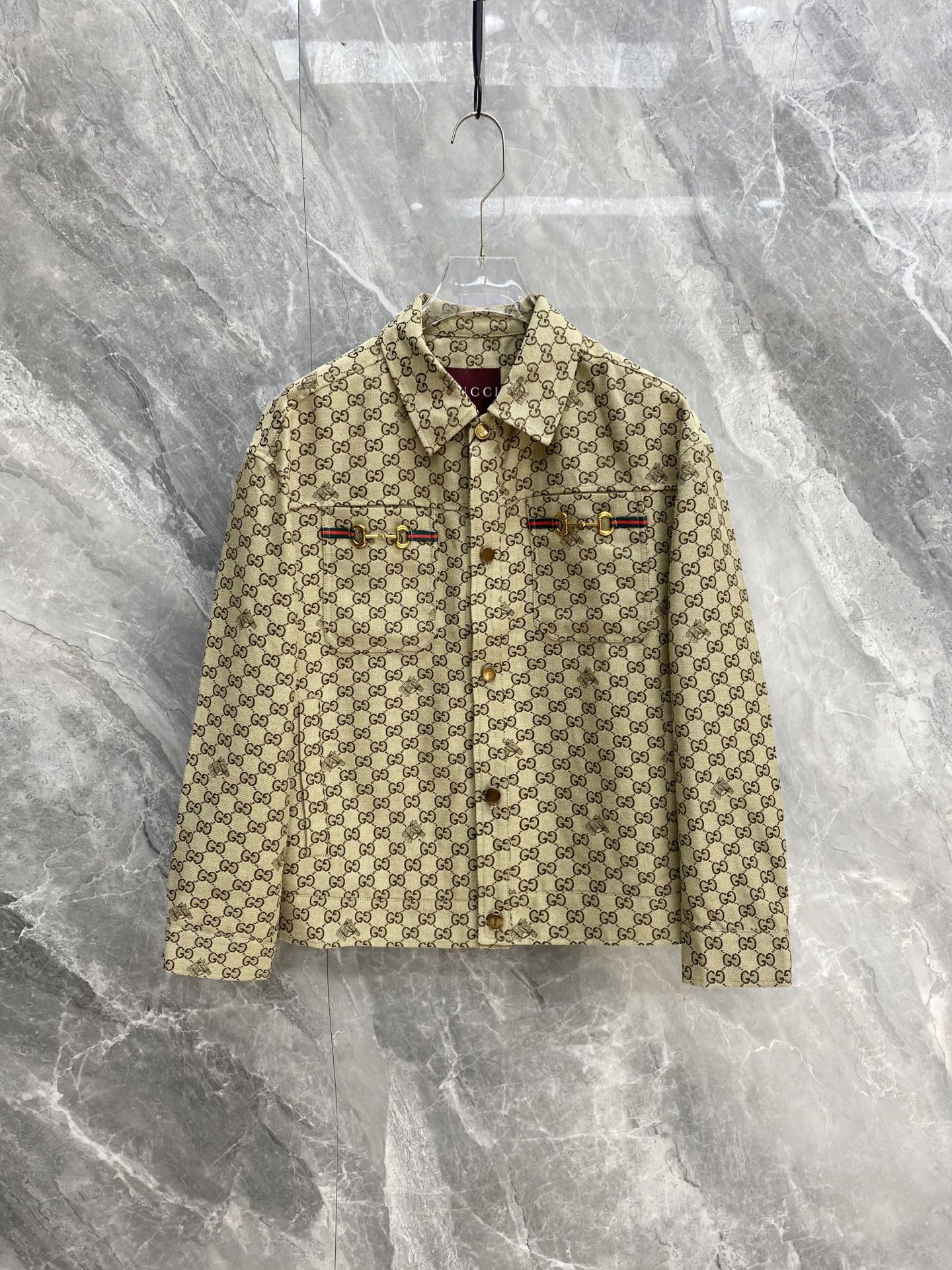 NO:956563,Gucci 2026 autumn and winter heavy new presbyopic work jacket. Classic all-over printed double G jacquard fabric, thick and crisp, full of atmosphere in autumn and winter. Lapel work cut, loose shoulders are not flattering. Red and green webbing on the chest + metal horsebit iconic hardware, retro gold buckle details are exquisite. Light khaki background is gentle and versatile. It can be worn alone or layered with sweaters and sweaters. It can be used for commuting, daily use and travel. It is the same style for men and women.  Size M-3XL,,gucci,gucci,hoodie,sweatshirts,jackets & coats,sweaters,19860909Gucci 古驰 2026秋冬重磅新款老花工装夹克 经典满印双G提花面料,厚实挺括,秋冬穿氛围感拉满 翻领工装剪裁,宽松落肩不挑身材 胸前红绿织带+金属马衔扣标志性五金,复古金扣细节精致到位 浅卡其底色温柔百搭,单穿叠搭毛衣卫衣都高级 通勤、日常、出行一件搞定,男女同款轻奢刚需款 码数M-3XL,,gucci,gucci,hoodie,sweatshirts,jackets & coats,sweaters,,Men's clothing
