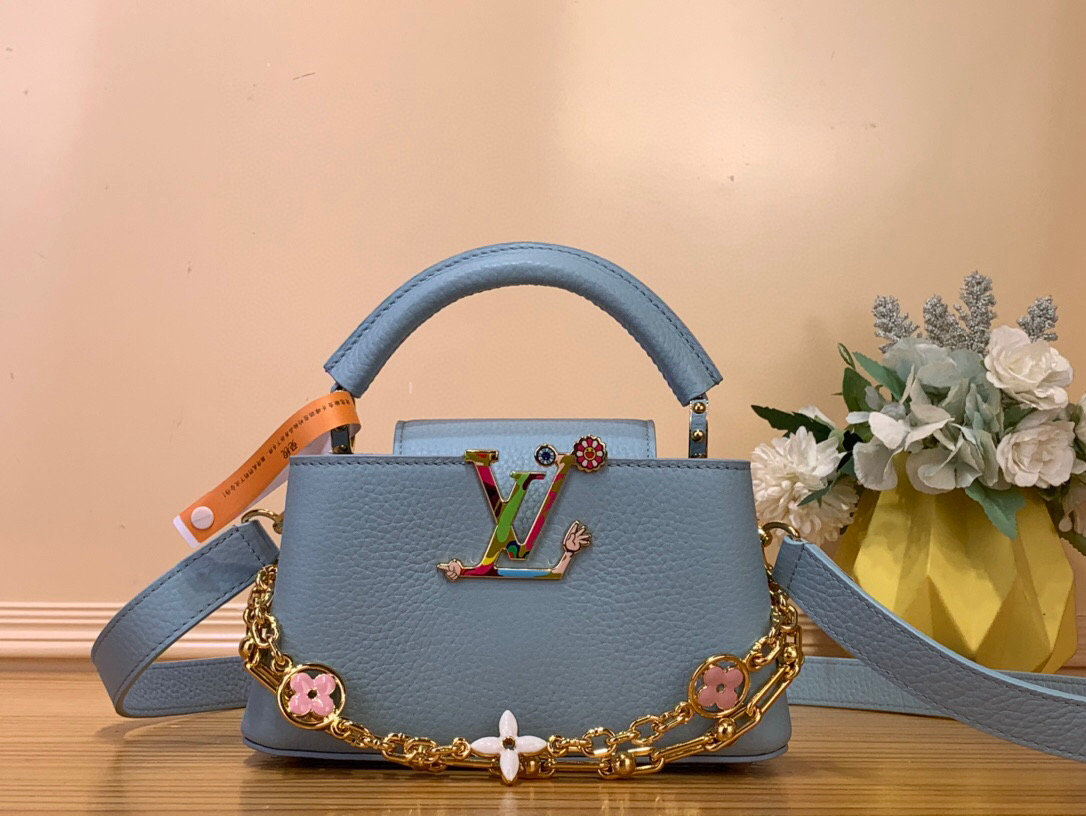 NO:551754,Top Original [LV x TM - Sac Caucines East West Mini] m13707 Blue/Takashi Murakami This Caucines East West Hr mini bag is an extraordinary piece transformed by the playful code of the Louis Vuitton  Borrowed from Murakami's original rainbow palette. The iconic LV initials on the front and the Monogram flower on the upgraded chain are reinvented in an original way in the artist's own Suerflat style. Dimensions 22x12x8 cm 118121350 (LxHxW),,louis vuitton,louis vuitton,mini bags19860909顶级原单【LV x TM - Sac Caucines East West Mini】 m13707 蓝色/ 村上隆 这款Caucines East West Hr迷你包是Louis Vuitton x Murakami系列重新发行的俏皮代码所改变的非凡作品.他穿着柔和的蓝色Taurillon皮革,这种颜色是从Takashi Murakami的原始彩虹调色板中借来的.正面标志性的LV首字母和升级链条的Monogram花以艺术家自己的Suerflat风格以原创方式重新发明. 尺寸22x12x8厘米 118121350（长x高x宽）,,louis vuitton,louis vuitton,mini bags,Bag