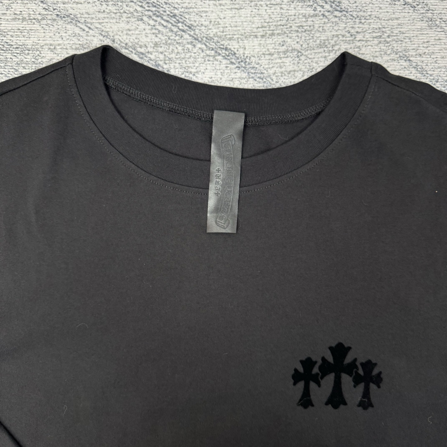 Chrome Hearts/ 克罗心CH 黑色植绒十字架圆领长袖

Size：S/M/L/XL 💰p205

定织定染40纱表纹带有擦毛感面料，成衣做YB一致静电植绒工艺，非一般普通刻字模工艺，角度不同颜色也有区别。全新款领标（非之前皮标）以及洗标。
