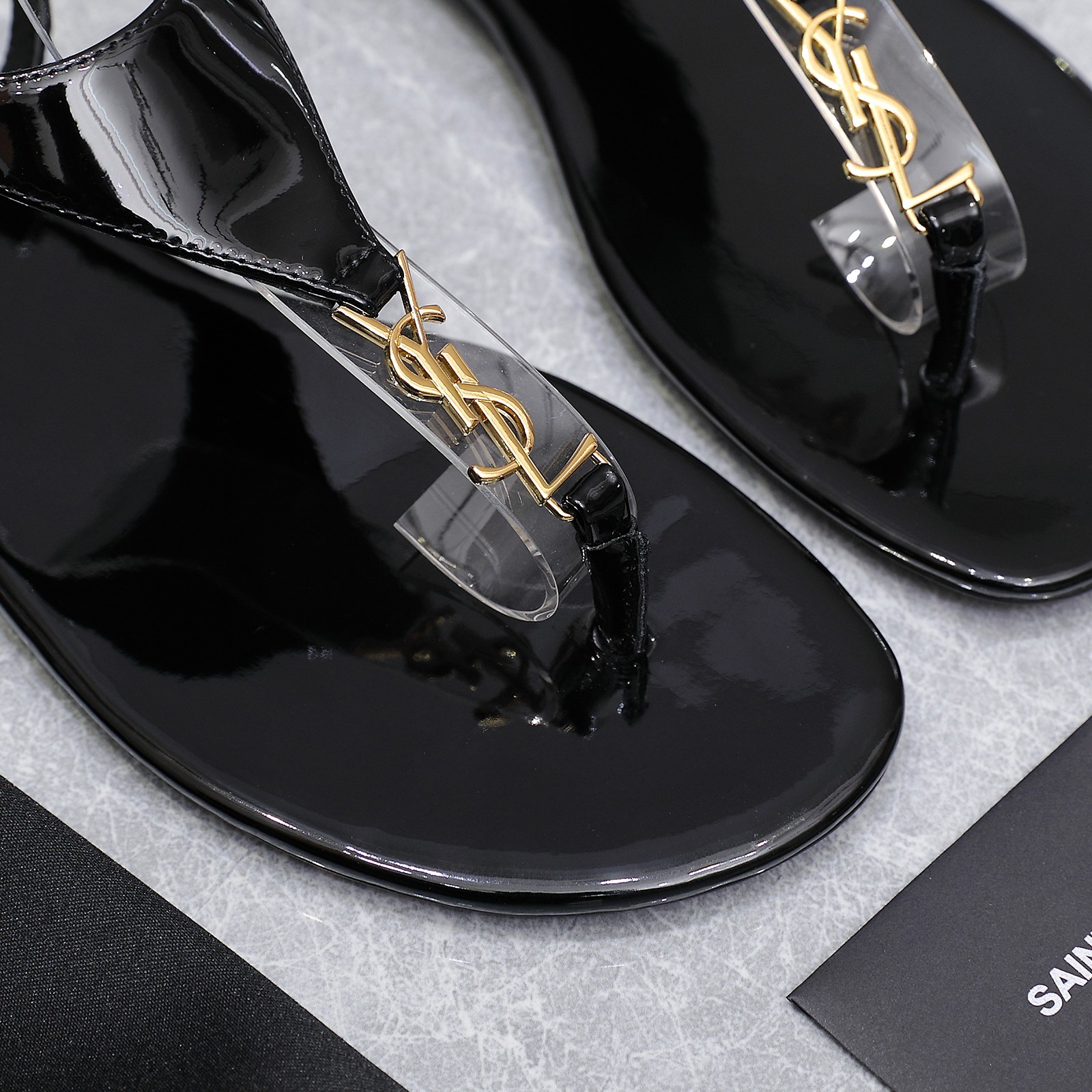 Saint Laurent Women's Cassandre Thong Sandals in Patent Leather Black 10 a1745067394371 8102