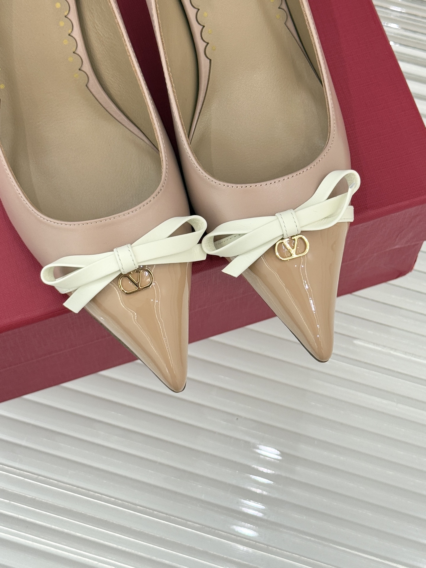 Valentino/华伦天奴经典尖头蝴蝶结高跟鞋以标志性小V扣镌刻意式奢雅将利落锋芒与温柔浪漫完美平衡。