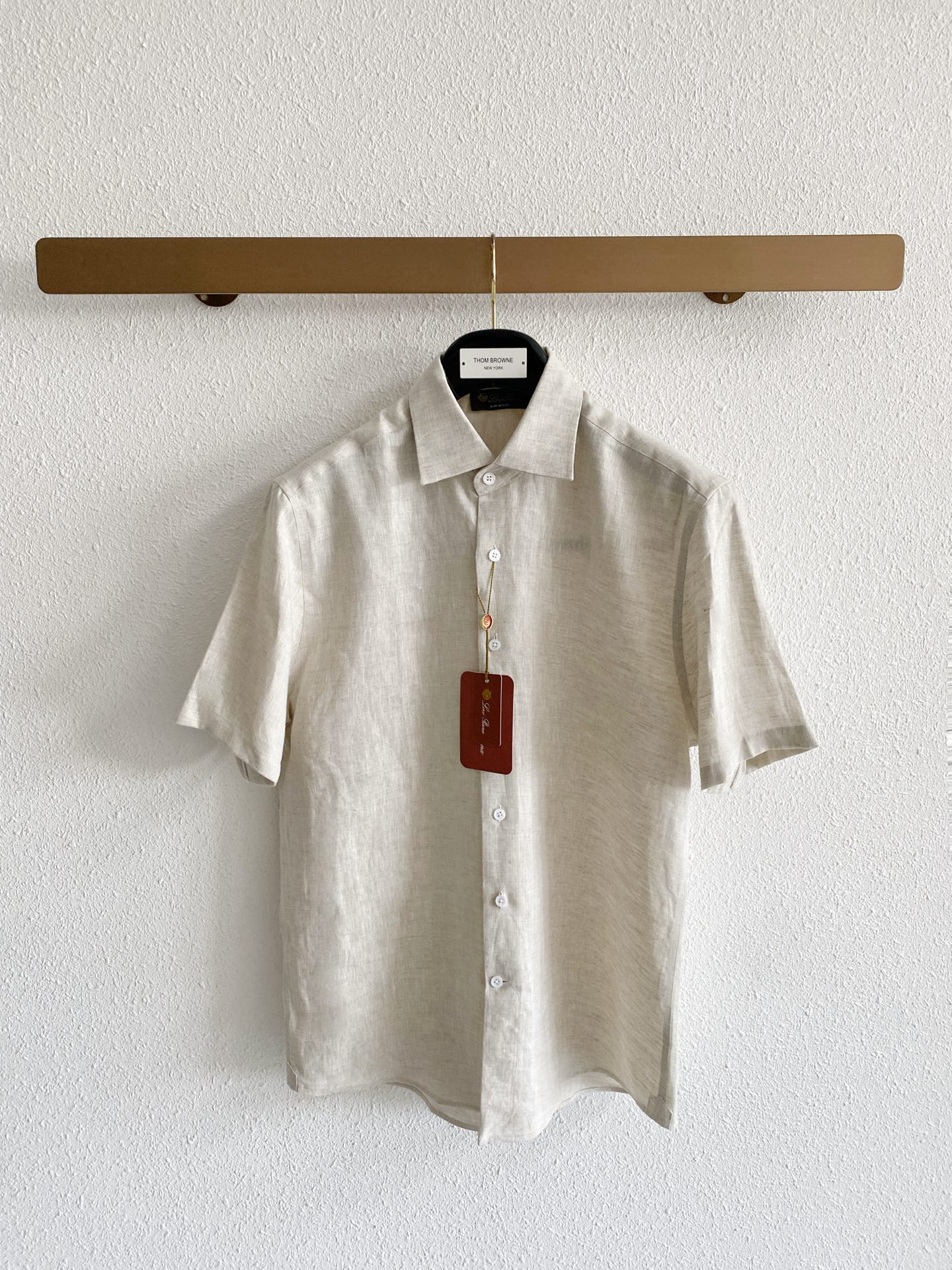 NO:936097,Loro Piana pure linen short-sleeved luxury shirt fabric is made of high-quality natural linen fabric, which has been refined and softened before treatment to weaken the raw and itchy touch of native linen, making the upper body skin-friendly and comfortable. The fabric has a natural and fine fiber texture, showing a high-end matte matte look and feel, without the dazzling glossy effect.  The flax fiber has sufficient breathable pores, and the short-sleeved version is suitable for hot weather. It conducts heat quickly and can quickly discharge sweat during daily travel, making it less likely to get sticky on the back. The subtle wrinkles formed in the fabric every day have a casual atmosphere, and the light colors have been processed through a color fixation process, so they will not turn yellow or old easily after repeated washing. Version and details  The silhouette adopts a slightly loose front-shoulder cut suitable for summer. The shoulder line is neatly processed, which is better tolerant to body shapes with slippery shoulders, unbalanced shoulder width, and fat on the upper abdomen. The short sleeves are moderately cut and will not get stuck on the forearms and cause a sense of cramping. The classic and regular pointed collar has a built-in invisible shaping layer. The collar remains crisp even after frequent washing in summer. The buttons are fully buttoned to suit light business scenes. Unbutton the top button to switch to a casual style.  The placket is neatly and concealed, the button style is simple and low-key, and there is no exposed brand logo on the whole; the hem is cut with an arc, which can be tucked into trousers to create a neat commuting look, or worn outside for daily relaxation, and the details are exquisite and exquisite. The color selection is pure white with a clean and translucent look, which is full of visual freshness in summer. It is suitable for trousers and shorts of various colors. It is highly suitable for workplace commuting and formal gatherings. It is highly layered when paired with dark bottoms;  The original linen beige color retains the original natural tone of linen. The tone is warm and soft, and the stain resistance is stronger. It is suitable for daily commuting and holiday travel. The style is lazy and retro, and the daily wear tolerance is higher. Size M-4XL,,loro piana,shorts,shirts,T-shirt,19860909Loro Piana纯亚麻短袖静奢衬衫 面料 甄选优质天然亚麻面料,经过精细化柔化预处理,弱化原生亚麻生硬刺痒的触感,上身亲肤舒适. 面料自带自然细密的纤维肌理,呈现高级哑光雾面观感,没有刺眼的亮面效果. 亚麻纤维透气孔隙充足,短袖版型适配酷暑天气,导热速度快,日常出行能够快速排出汗液,不容易出现后背闷湿黏身的状况. 面料日常形成的细微褶皱自带随性氛围感,浅色系经过固色工序处理,反复水洗不容易发黄发旧. 版型与细节 版型采用适配夏季的微宽松正肩剪裁,肩线处理利落,对溜肩、肩宽失衡、上腹有赘肉的身形包容性较佳,短袖袖长剪裁适中,不会卡在小臂位置造成局促感. 经典规整小尖领内置隐形定型层,夏季频繁清洗之后领口依旧挺括,扣齐纽扣适配轻商务场景,解开最上方一粒纽扣便可切换休闲穿搭风格. 门襟走线工整隐蔽,纽扣样式简约低调,整体没有张扬外露的品牌标识； 下摆沿用圆弧剪裁,既可以塞入西裤塑造利落通勤造型,外放穿着也松弛日常,细节做工精致考究. 配色选择 纯白色观感干净透亮,夏日视觉清爽度拉满,适配各类色系的长裤、短裤,职场通勤、正式小聚适配度很高,搭配深色下装层次感突出； 原生麻米色保留亚麻原生自然色调,色调温润柔和,耐脏性能更强,日常通勤、假日出游都很适配,风格慵懒复古,日常穿搭容错率更高. 码数M-4XL,,loro piana,shorts,shirts,T-shirt,,Men's clothing