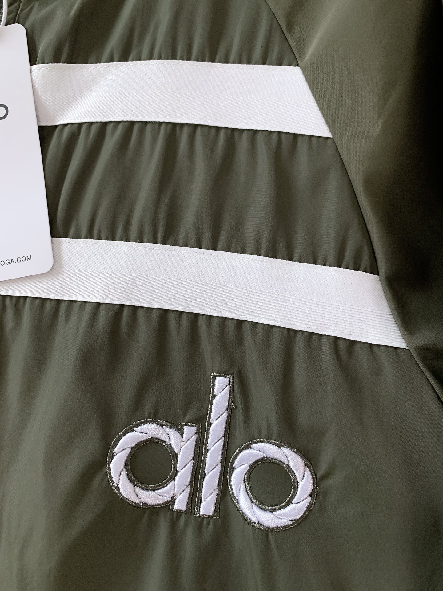 ALO 阿洛 2025FW早秋新品 连帽运动外套。它以轻量防风的面料打造利落廓形，连帽设计可随天气与造型