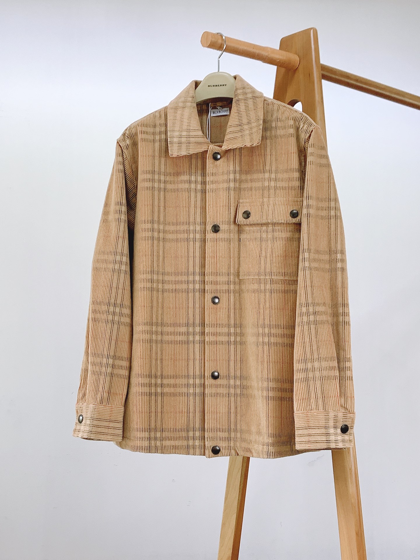 NO:662532,Burberry Plaid Corduroy Jacket Shirt is a dual interpretation of classics and textures. 1. The collision of retro corduroy fabrics and classic plaid. The outer layer is made of plaid corduroy fabric. The velvet texture of the corduroy is soft and waxy and full of retro charm. The plaid is the soul logo of BBR. The khaki background is intertwined with black and red lines, making it full of classic recognition. It not only retains the retro tone of corduroy, but also injects the brand's unique British genes.  The inner lining is Burberry's classic plaid lining, which echoes the outer plaid. The details show the brand heritage while enhancing the comfort and high-end feeling of wearing. 2. Integration of design workwear style and exquisite details. The version adopts a jacket-style shirt version, which is loose and moderate, with the neatness of a shirt and the practicality of a jacket. It can be worn alone or stacked, adapting to a variety of styles and scenes. The lapel collar design is crisp and stylish, modifying the neck line and adding a capable temperament.  Pockets and buttons The workwear-style pockets on the chest are paired with brand-engraved metal buttons. The button details are exquisite and elegant, which is not only a practical design, but also a low-key expression of the brand identity. The placket and cuff buttons echo the same, and the overall style is unified and rich in texture. Whether it is the alignment process of corduroy velvet strips or the plaid splicing of the lining, every stitching is neat and delicate, reflecting the craftsmanship of high-end clothing. 3. Symbiosis of retro British style and modern fashion  It can be a representative of retro British style, paired with high-waisted straight pants and Chelsea boots to replicate the classic British style; it can also be integrated into modern casual style, combined with jeans and white shoes to create a casual and uninhibited daily wear; even in urban commuting scenes, worn with a shirt inside and a suit outside, it can stand out with its unique plaid corduroy texture.  From the ingenuity of the fabric to the details of the design, to the diverse adaptation of styles, this plaid corduroy jacket-style shirt is undoubtedly a perfect blend of classics and textures, injecting a unique British charm into the outfit. ……………………………………………… SizeS-XL,,burberry,burberry,boots,jeans,jackets & coats,shirts,business suit, 19860909Burberry 巴宝莉 格纹灯芯绒外套式衬衫 经典与质感的双重演绎. 一、面料复古灯芯绒与经典格纹的碰撞 外层采用格纹灯芯绒面料,灯芯绒的绒条质感软糯且富有复古韵味,格纹则是BBR的灵魂标识,卡其底色交织黑、红线条,经典辨识度拉满,既保留了灯芯绒的复古腔调,又注入了品牌独有的英伦基因. 内衬是巴宝莉经典格纹里布,与外层格纹形成呼应,细节处尽显品牌传承,同时提升穿着的舒适感与高级感. 二、设计工装风格与精致细节的融合 版型采用外套式衬衫版型,宽松有度,兼具衬衫的利落与外套的实穿性,可单穿可叠搭,适配多种风格与场景. 领口翻驳领设计,挺括有型,修饰颈部线条,增添干练气质. 口袋与纽扣胸前工装风口袋搭配镌刻品牌金属纽扣,纽扣细节精致考究,既是实用设计,也是品牌身份的低调彰显；门襟与袖口纽扣与之呼应,整体风格统一且富有质感. 做无论是灯芯绒的绒条对齐工艺,还是里布的格纹拼接,每一处缝线都工整细腻,体现出高端服饰的工艺水准. 三、风格复古英伦与现代时尚的共生 它可以是复古英伦风的代表,搭配高腰直筒裤与切尔西靴,复刻经典英伦造型；也能融入现代休闲风,与牛仔裤、小白鞋组合,打造随性不羁的日常穿搭；甚至在都市通勤场景中,内搭衬衫、外穿西装,也能凭借独特的格纹灯芯绒质感脱颖而出. 从面料的巧思到设计的细节,再到风格的多元适配,这件格纹灯芯绒外套式衬衫,无疑是经典与质感的一次完美交融,为穿搭注入别样的英伦魅力. …………………………………………………… SizeS-XL,,burberry,burberry,boots,jeans,jackets & coats,shirts,business suit, ,Men's clothing