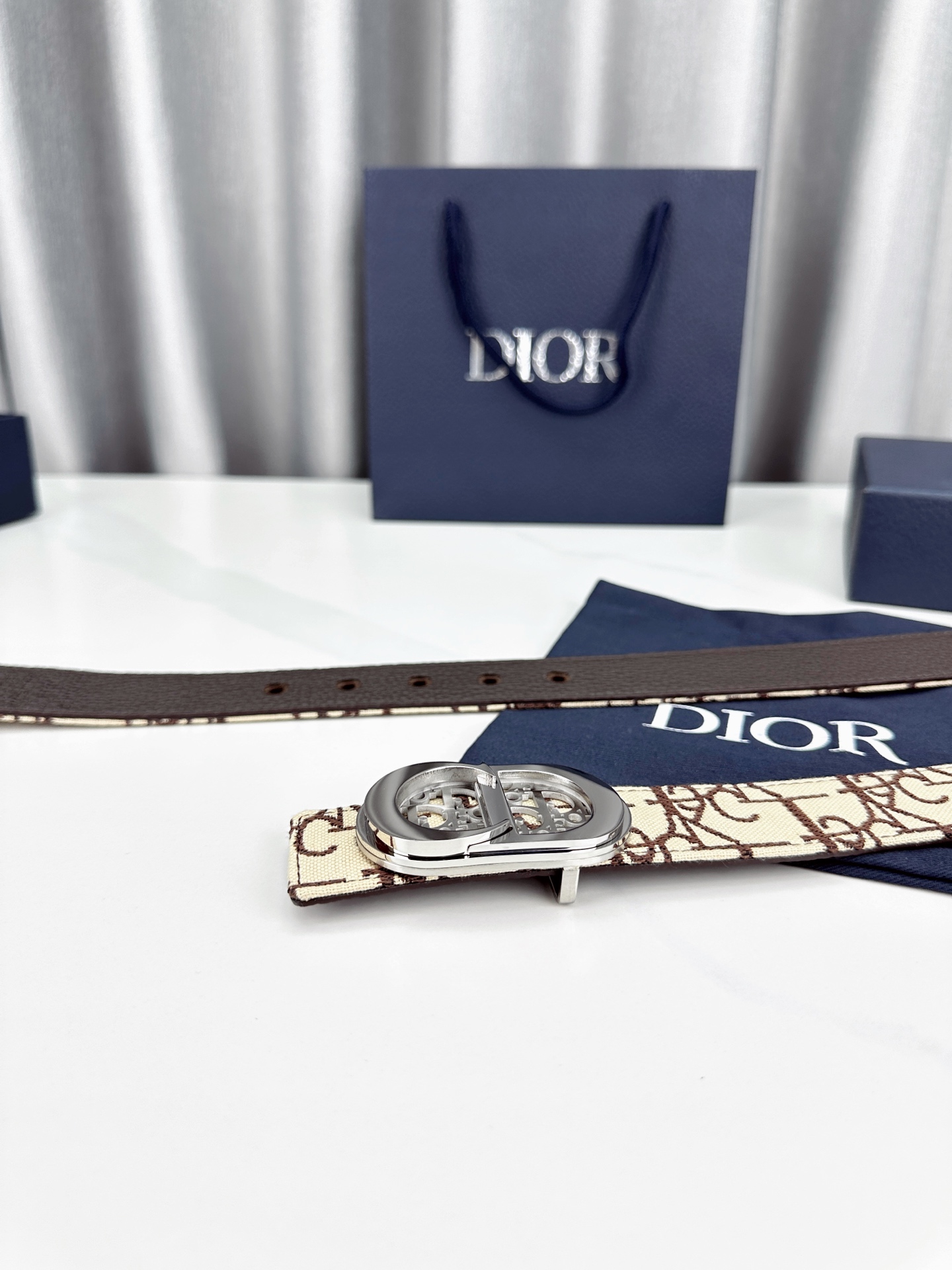 宽度3.5cm 这款腰带扣以 Oblique Cosmo 图案金属饰牌诠释品牌经典图案，以金色/白色饰面