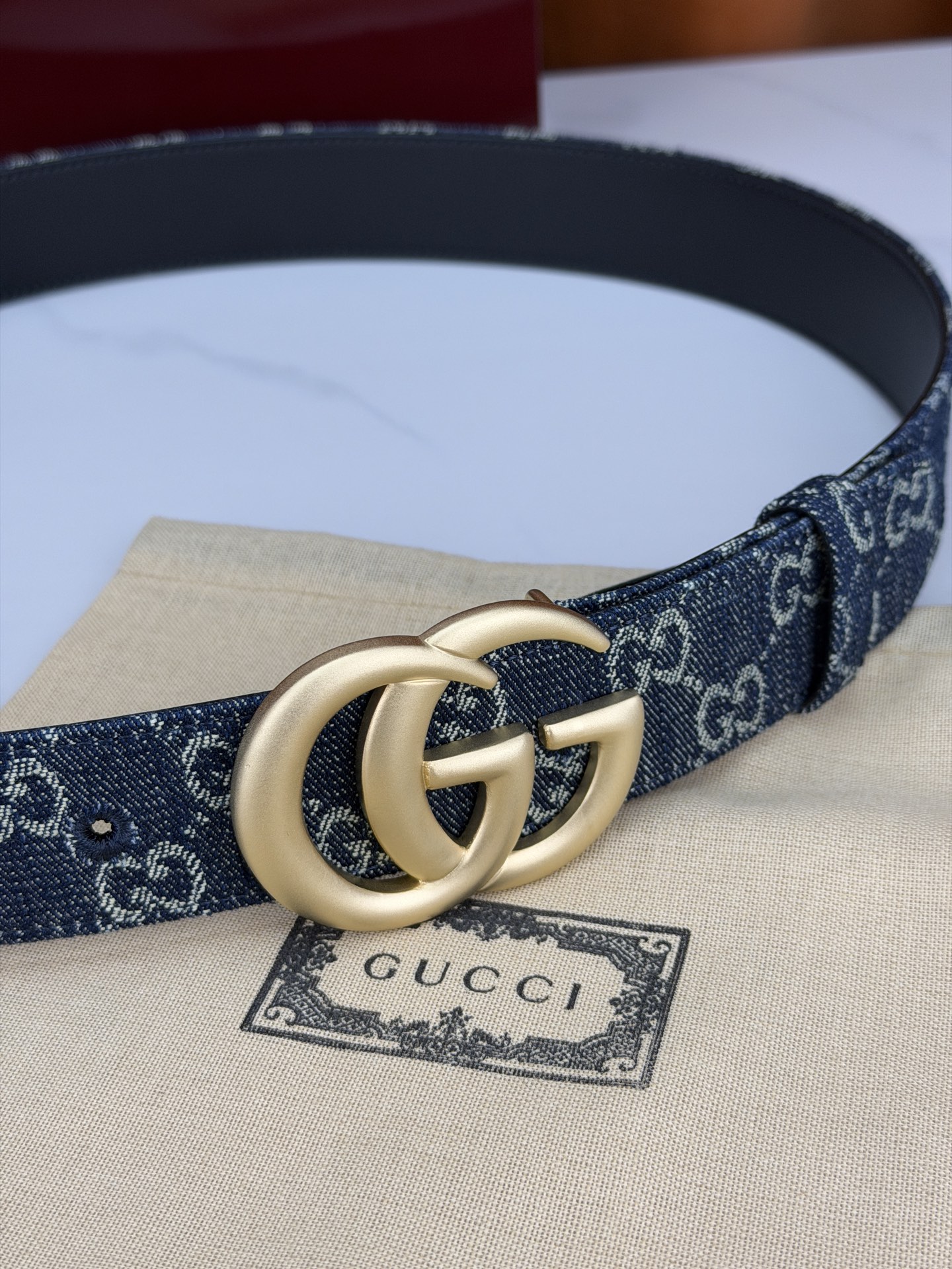 GUCCI 4.0cm宽度老花帆布腰带，深蓝底色织满GG经典提花，反面黑色光面皮革双面从容。立体双G金属