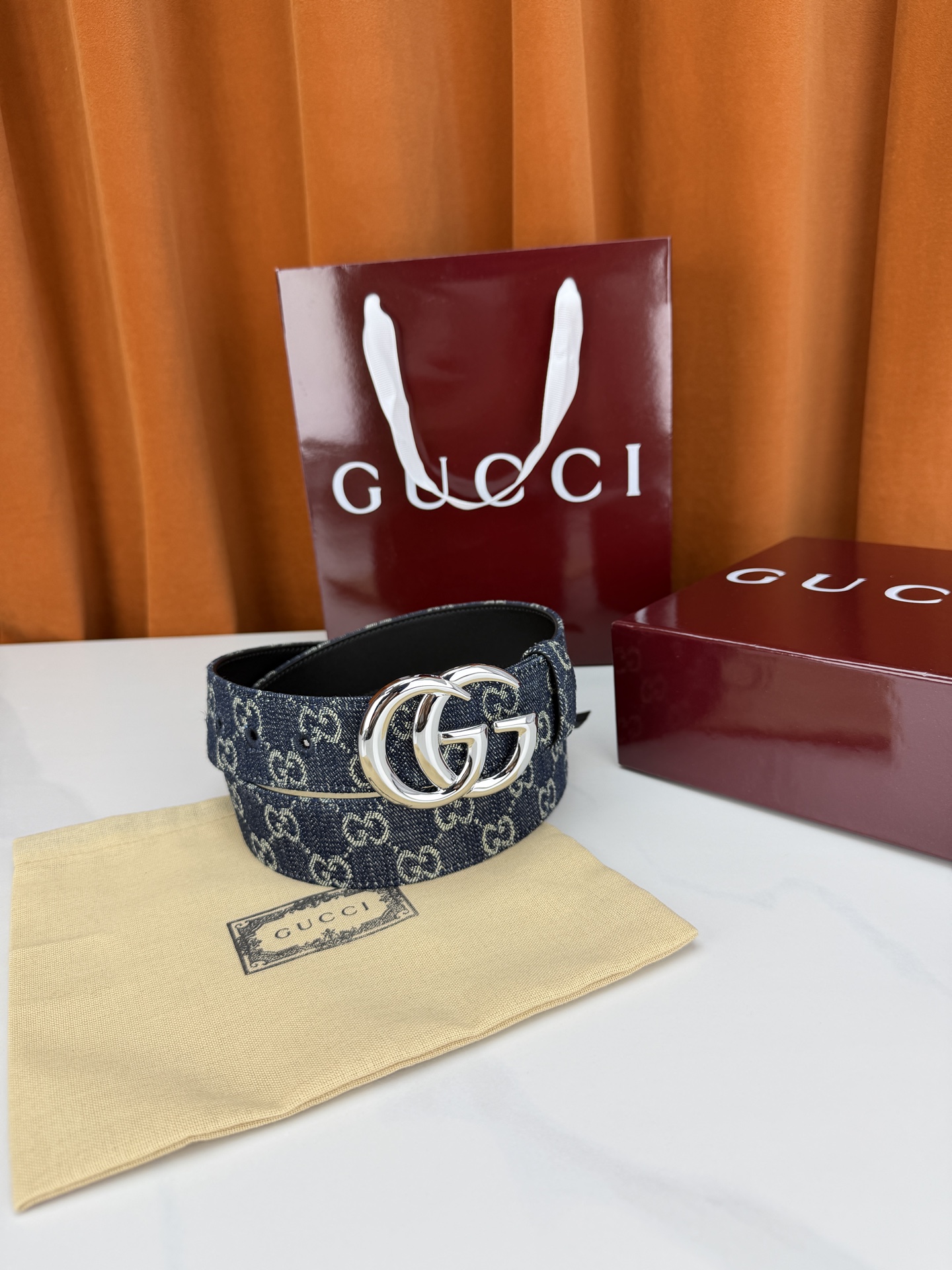 GUCCI 4.0cm宽度老花帆布腰带，深蓝底色织满GG经典提花，反面黑色光面皮革双面从容。立体双G金属