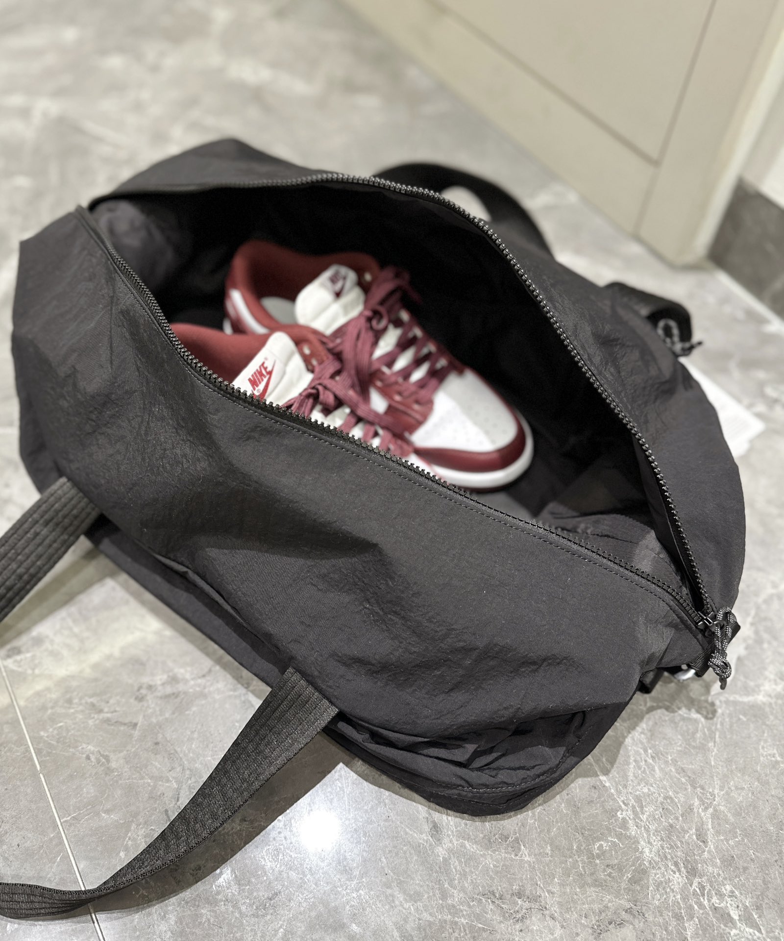The spacious interior accommodates footwear, apparel, a laptop, an - Comprehensive 9
