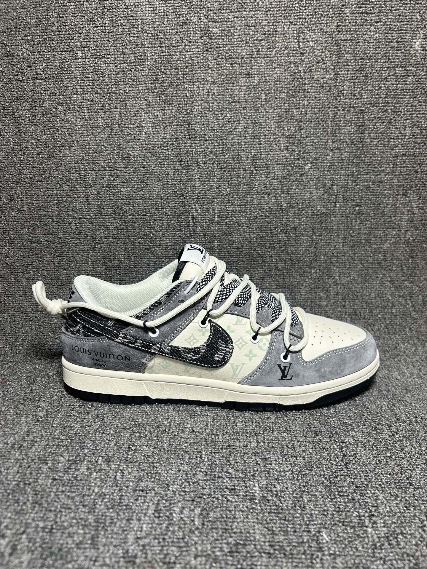 解构奢潮,低帮新章|Nike Dunk Low x Louis Vuitton联名款!当Nike Dunk Low的复古街头基因遇上Louis Vuitton的奢雅解构美学,这双成为奢潮跨界的又一惊艳之作,将复古与奢华的碰撞演绎到极致. 鞋身以灰调为主旋律,深灰翻毛皮革与浅米皮革拼接出丰富的材质层次,鞋侧暗藏的LV经典Monogram老花暗纹,为街头鞋型注入低调奢华的底蕴.解构主义设计的牛仔布Swoosh打破常规,黑白格纹布料点缀鞋帮,搭配双色系带与金属鞋扣,每一处细节都彰显着联名的匠心巧思.鞋头的红色LV标识、后跟的“LOUIS VUITTON”字样,更是将奢潮身份直接拉满,成为足下最吸睛的符号. 米白中底搭配黑色外底,延续Dunk Low经典的复古轮廓与舒适脚感,让奢潮风格不再局限于视觉,更能适配日常穿搭的每一个场景.无论是复古风搭配还是高街造型,这双联名款都能以解构奢潮的独特魅力,让你轻松成为街头与时尚圈的双重焦点. 货号:CX5050-Y49 5.96