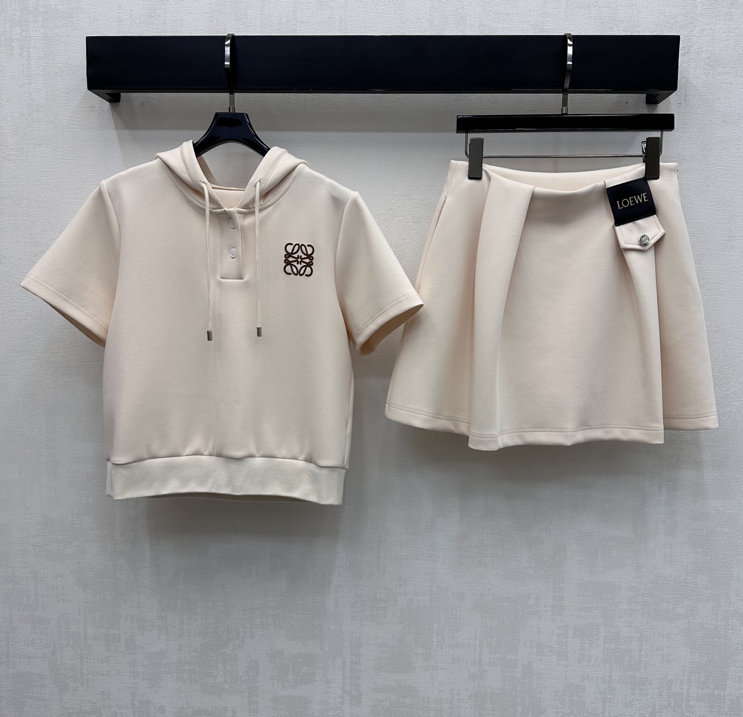 NO:752200,Loew*2026 new arrivals hooded sweatshirt skirt suit customized YB imported elastic air cotton material with elastic and lustrous texture. The chest is decorated with the iconic logo waist and hip letter leather plate to highlight the brand tone. The loose version is relaxed and tolerant. It is not picky about the figure. The development of fabrics and accessories. The hooded drawstring short-sleeved sweatshirt is matched with the pleated skirt of the same series. The details echo up and down. The side waist zipper adjustment design is convenient and comfortable to show the cool sports style. The complete set shows the vitality and age-reducing youthful style.  High version 2 colors,,loewe,hoodie,sweatshirts,skirts,T-shirt,hats,19860909Loew*2026新品上架连帽卫衣半裙套装定制YB进口弹力空气棉材质 质感弹力光泽 胸前以标志性徽标腰胯字母皮牌装饰 彰显品牌调性 宽松版型松弛包容 不挑身材 面辅料开发 连帽抽绳短袖卫衣搭配同系列压褶短裙 细节上下呼应 侧腰拉链调节设计便捷舒适 展现潮酷运动风 成套穿搭尽显活力减龄青春风格   高版本2色,,loewe,hoodie,sweatshirts,skirts,T-shirt,hats,,Women's clothing