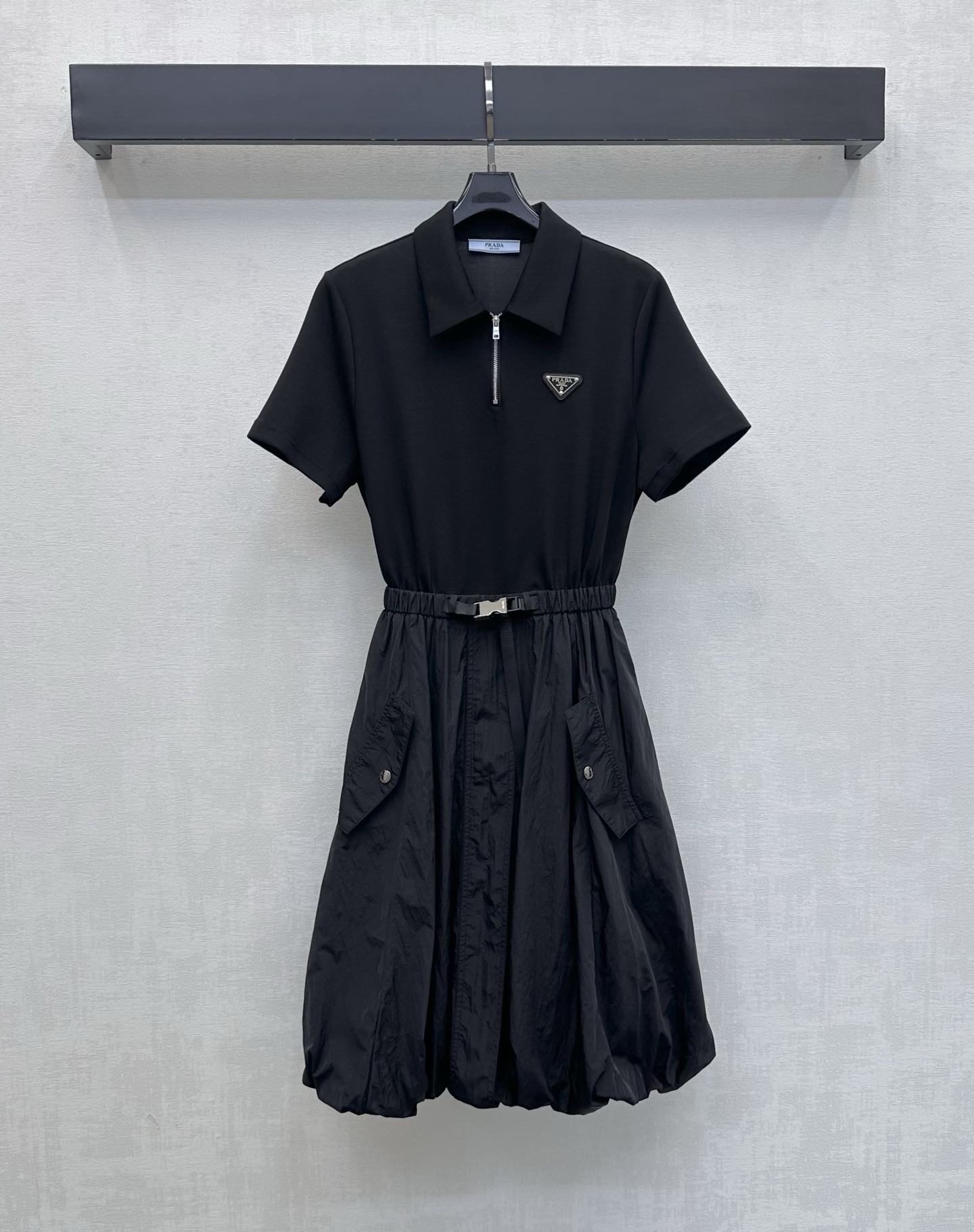 NO:844540,Prad*2026 new arrivals Flower bud belt dress is made of YB imported twill cotton nylon material. Comfortable, breathable and stylish. Decorated with the iconic letter triangle logo on the chest to highlight the brand's tone. Half-open zipper adjustment with buckle webbing waist design adds a sense of layering to the look. It outlines the waistline and elongates the proportion of the lower body, making it visually taller. The fluffy flower bud silhouette at the hem is individual and eye-catching. Full score for age reduction effect. Development of surface accessories  Lapel short-sleeved dress tailoring. Pair it with Martin boots or dad shoes. Easily look like a street trendy person. High version 2 colors, prada, boots, skirts, T-shirt,19860909Prad*2026新品上架花苞腰带连衣裙定制YB进口斜纹棉尼龙材质 舒适透气有型 胸前点缀标志性字母三角徽标装饰 彰显品牌调性 半开襟拉链调节配合卡扣织带收腰设计 增添造型层次感 勾勒腰线拉长下半身比例 视觉上更显高挑 下摆蓬蓬花苞廓形个性吸睛 减龄效果满分 面辅料开发 翻领短袖连衣裙剪裁 搭配马丁靴还是老爹鞋 轻松打造街头潮人 高版本2色,,prada,boots,skirts,T-shirt,,Women's clothing