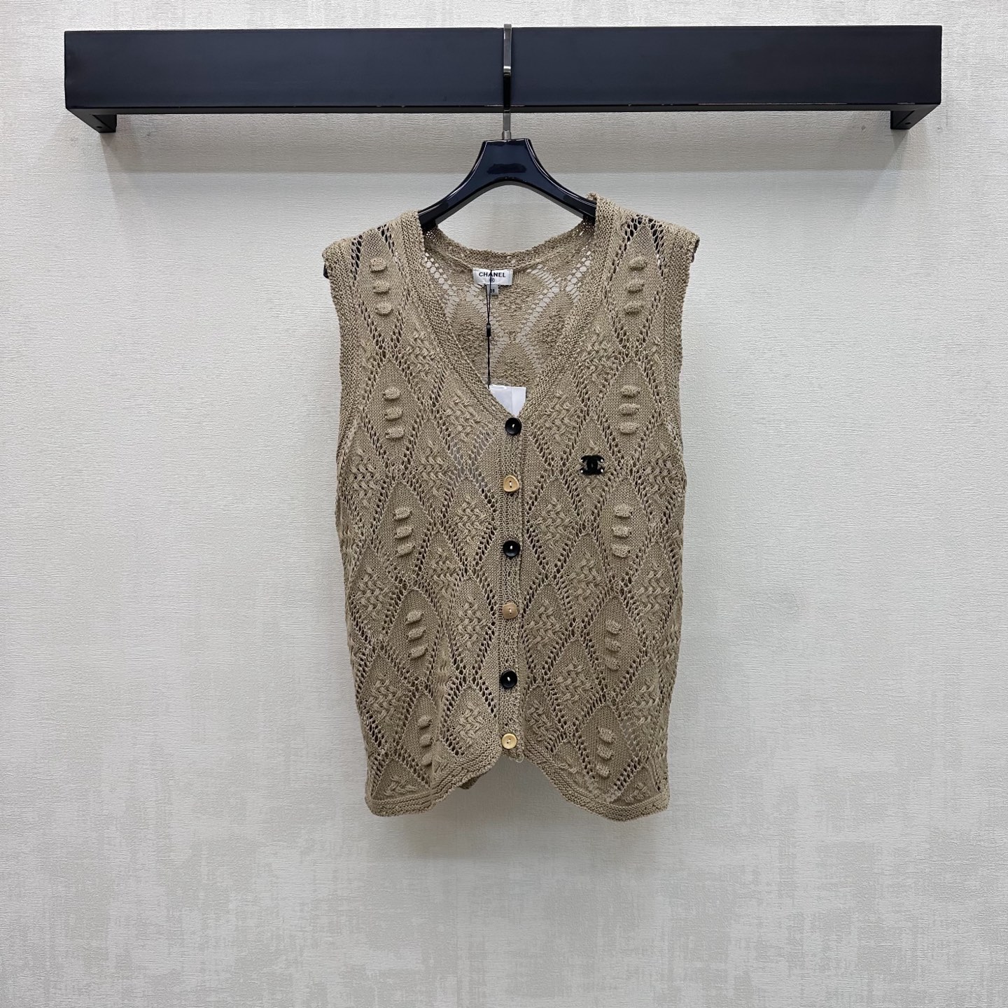 NO:845239,Chane*2026 new products on the shelves V-neck hollow knitted vest customized YB imported ice silk wool material. The texture is light and breathable, cool and smooth to the touch. The whole body is made of classic diamond hollow weaving technology to add layering to the look. Retro and elegant. The deep V-neck design modifies the neck line and makes the face smaller. Single row of contrasting buttons for adjustment. Decorated with the iconic double C letter logo on the chest to highlight the brand's tone. Sleeveless V-neck cardigan cut to cover the upper body and make the body look slimmer.  For daily vacations, you should wear refreshing and high-end beachwear. It has the lazy temperament of a French socialite. High version 2 colors 36 38 40,,chanel,19860909Chane*2026新品上架V领镂空针织马甲定制YB进口冰丝羊毛材质 质地轻薄透气 触感凉爽顺滑 通体采用经典菱格镂空编织工艺 增添造型层次感 复古优雅 深V领口设计修饰颈部线条显脸小 单排撞色纽扣调节处理 配合胸前点缀标志性双C字母徽标装饰 彰显品牌调性 无袖V领开衫版型剪裁 上身遮肉显瘦 日常度假还是海边穿搭清爽高级 自带法式名媛慵懒气质 高版本2色36 38 40,,chanel,,Women's clothing