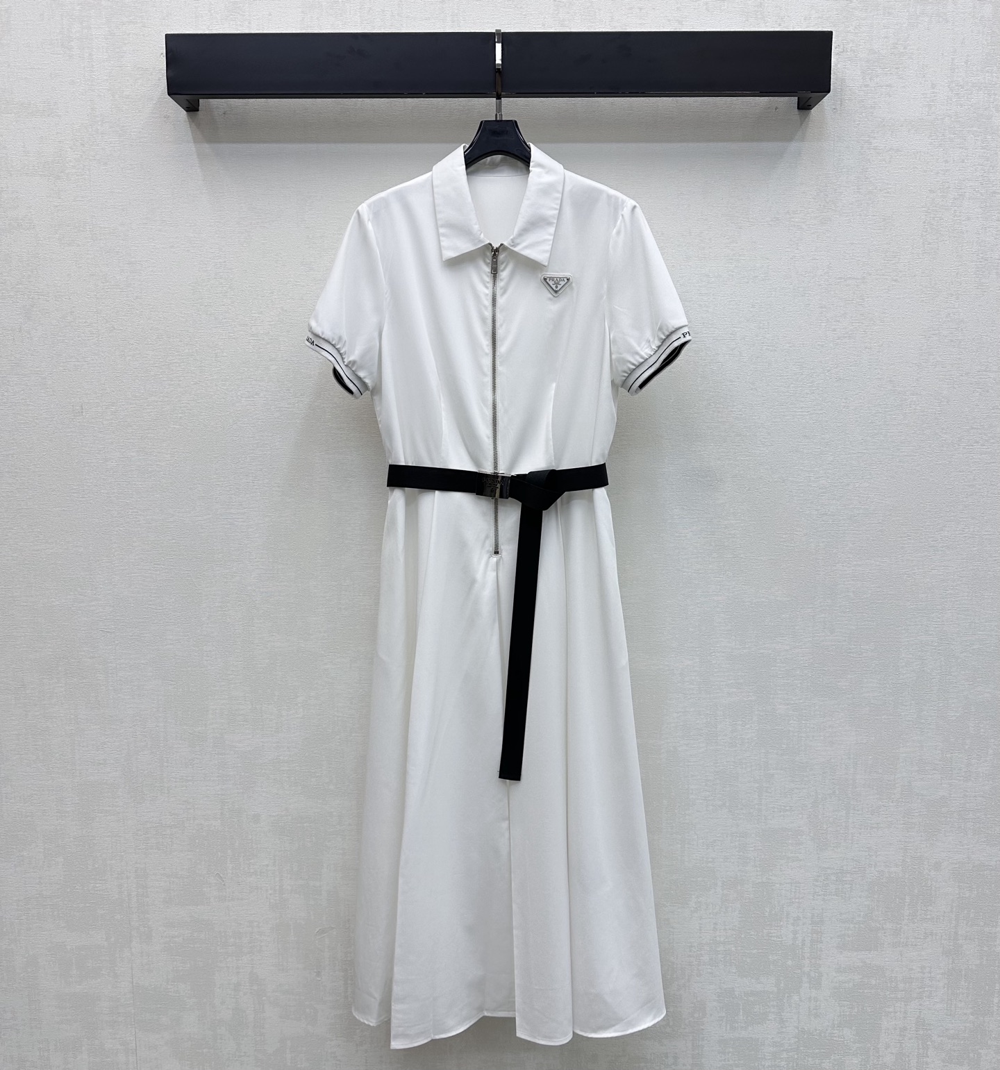 NO:875755,Prad*2026 New Arrival Lapel Belt Dress Customized YB Imported Tencel Cotton Material Comfortable, Breathable and Stylish Metal Triangle Logo Decorated with Iconic Letters on the Chest Highlights Brand Tonality Half-open zipper adjustment and buckle webbing waist design add layering to the look Outline the waistline and elongate the proportions of the lower body, visually making you appear taller Contrast color threads on the cuffs tighten individuality and eye-catching effect Full marks for age reduction effect Surface accessories development Lapel short-sleeved dress tailoring  High-end and fashionable daily commuting wear, high version 2 colors, prada, skirts, T-shirt,19860909Prad*2026新品上架翻领腰带连衣裙定制YB进口天丝棉纶材质 舒适透气有型 胸前点缀标志性字母金属三角徽标装饰 彰显品牌调性 半开襟拉链调节配合卡扣织带收腰设计 增添造型层次感 勾勒腰线拉长下半身比例 视觉上更显高挑 袖口撞色螺纹收紧个性吸睛 减龄效果满分 面辅料开发 翻领短袖连衣裙剪裁 日常通勤穿搭高级时髦 高版本2色,,prada,skirts,T-shirt,,Women's clothing