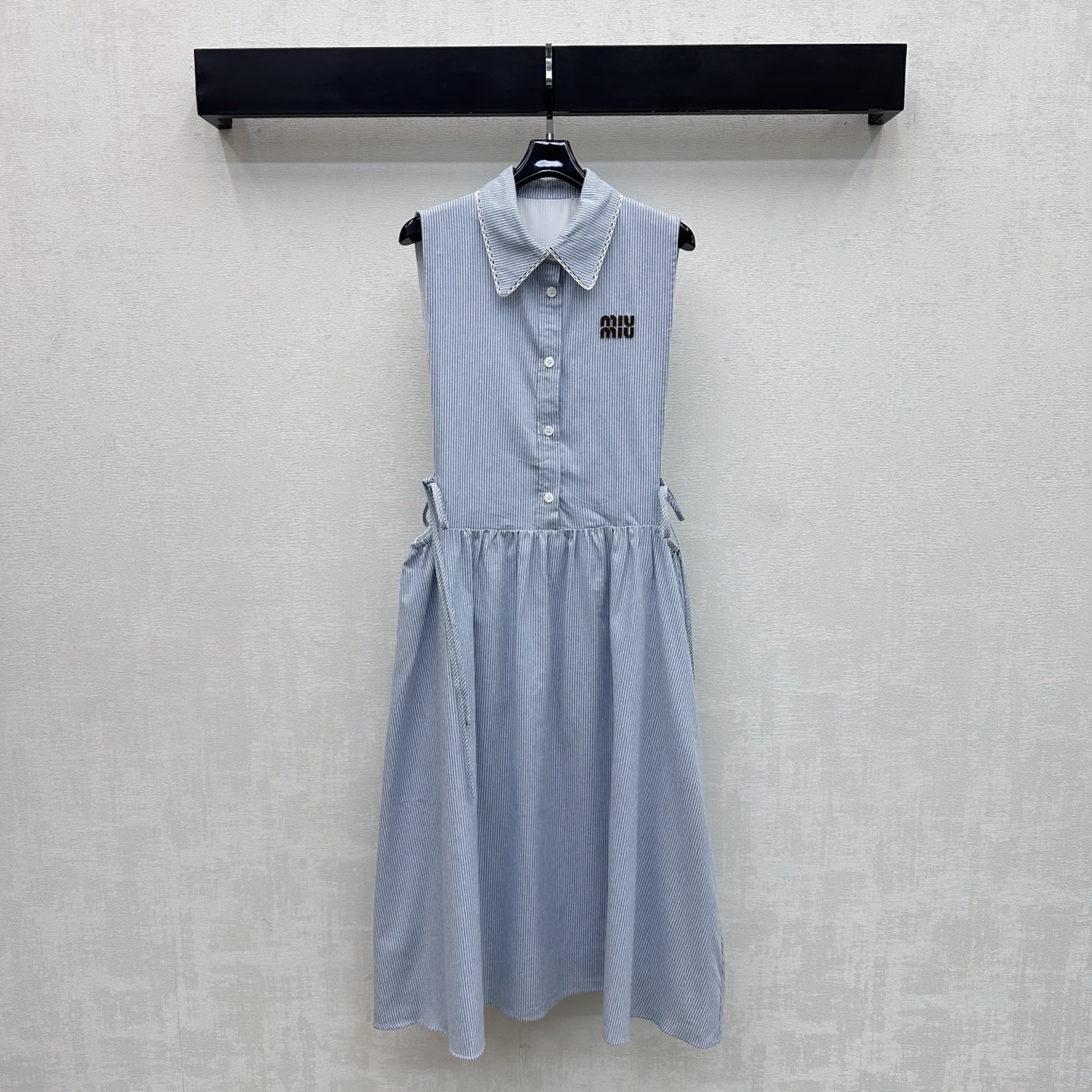 NO:878989,Miumi*2026 new products are on the shelves. The lapel waistless dress is made of YB imported cotton material. It is soft and comfortable. The collar is lace spliced ​​with a half-open button adjustment and waistband details to add layering to the look. The chest is embellished with the iconic letter leather label to highlight the brand's tone. Presenting the exclusive and well-behaved college style of the Miumi series. Surface accessories development. Lapel vest skirt tailoring. Wear to reduce age and youth. High version 2 colors,,miumiu,skirts,19860909Miumi*2026新品上架翻领露腰连衣裙定制YB进口全棉材质 柔软舒适 领边蕾丝花边拼接设计 配合半开襟纽扣调节与露腰系带细节处理 增添造型层次感 胸前点缀标志性字母皮标装饰 彰显品牌调性 呈现缪系专属乖巧学院风格 面辅料开发 翻领背心裙剪裁 穿搭减龄青春 高版本2色,,miumiu,skirts,,Women's clothing