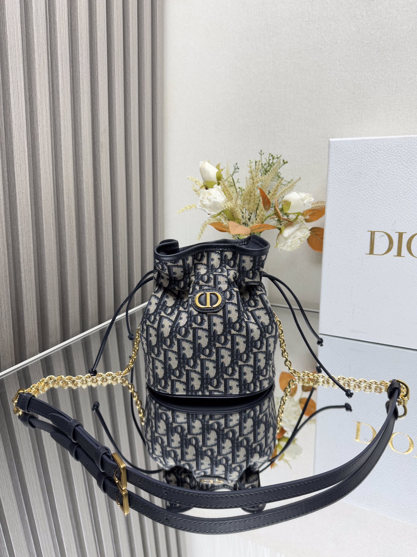 NO:773377,000490 This mini drawstring bucket bag is a new product of the 2025 early spring ready-to-wear series, enriching Dior Caro with a casual and elegant design  Series. Carefully crafted from blue cloth and other materials, decorated with oversized cannage stitching and CD logo on the front, with a drawstring compartment that can store a variety of daily necessities, and an adjustable chain shoulder strap, alternately made of vintage gold-finished metal links and enamel links of the same color as the leather. It is more comfortable with a leather strap. It can be carried by hand, shoulder or cross-body. Model: 2374 Size: 16x18.5x13, Dior, dior, dior19860909000490 这款迷你抽绳水桶包是二零二五早春成衣系列新品,以休闲优雅的设计丰富Dior Caro 系列.采用蓝布等材质精心制作,正面饰以超大藤格纹辑面线和CD标志,搭配抽绳隔层,可收纳各种日常用品,搭配可调节链条肩带,以复古金色饰面金属链环和与皮革同色调的珐琅链环交替打造,搭配皮革带更添舒适,可手提,肩背或斜挎, 型号:2374 尺寸:16x18.5x13,迪奥,dior,dior,Bag